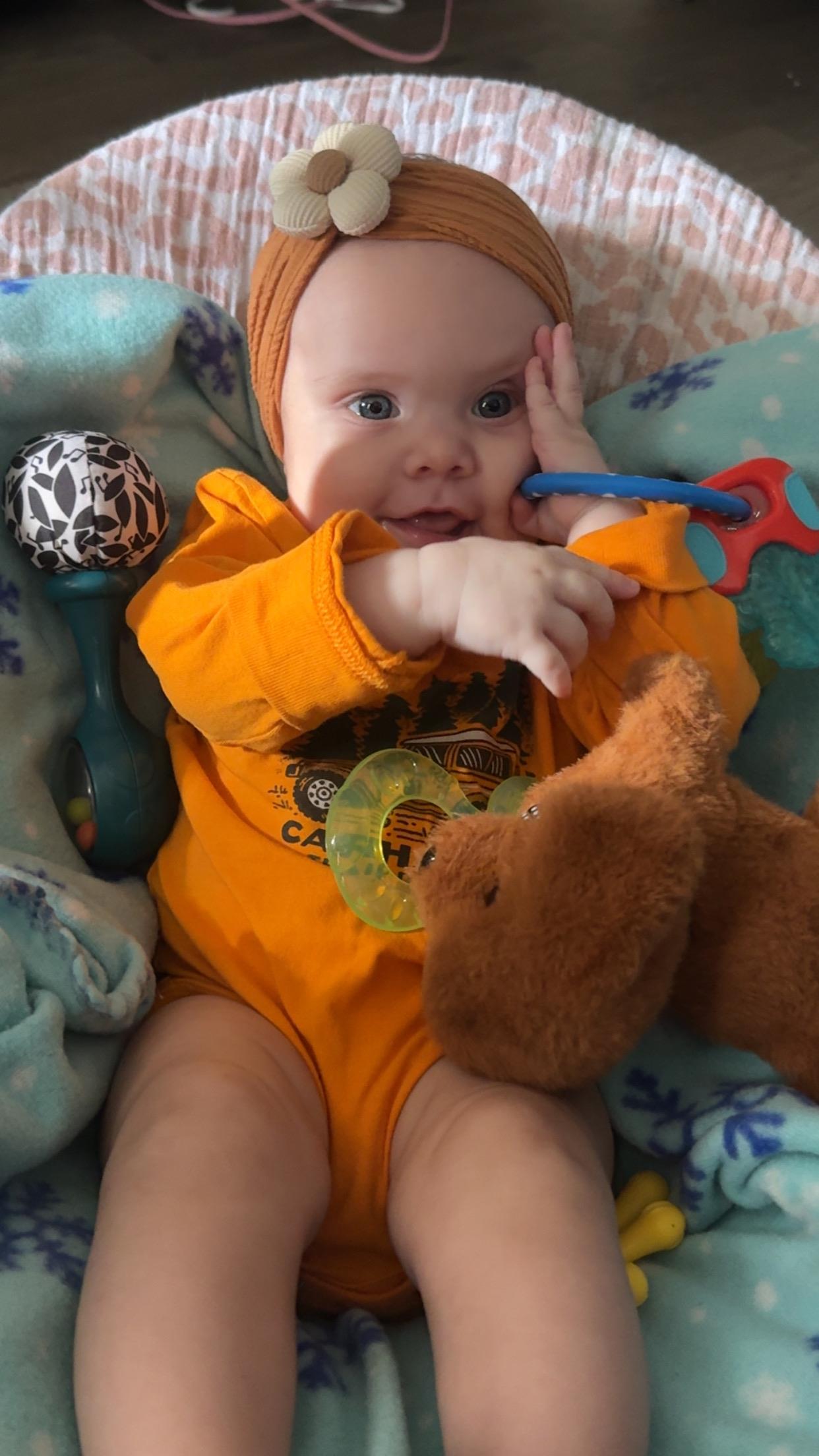 A baby holding a toy