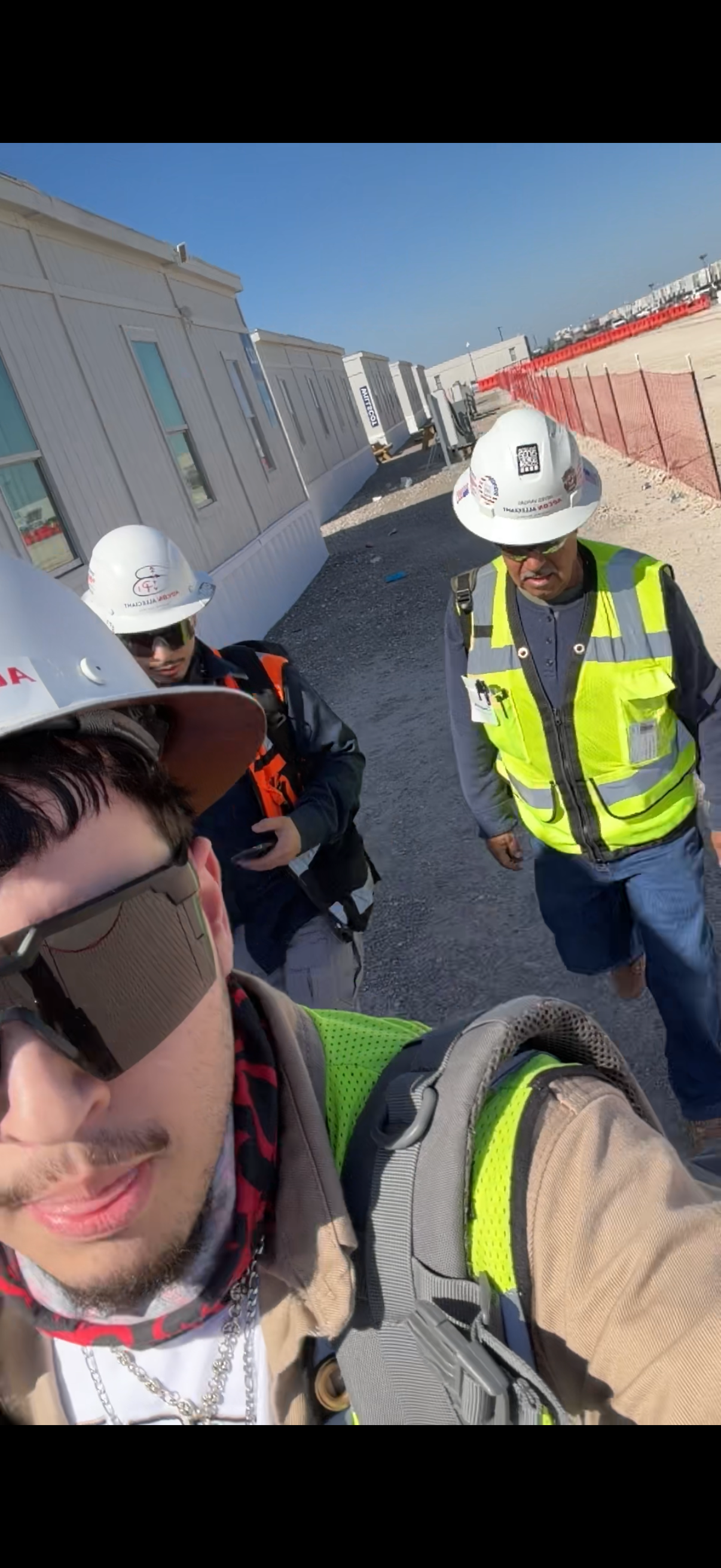 A group of men wearing hard hats and reflective vests