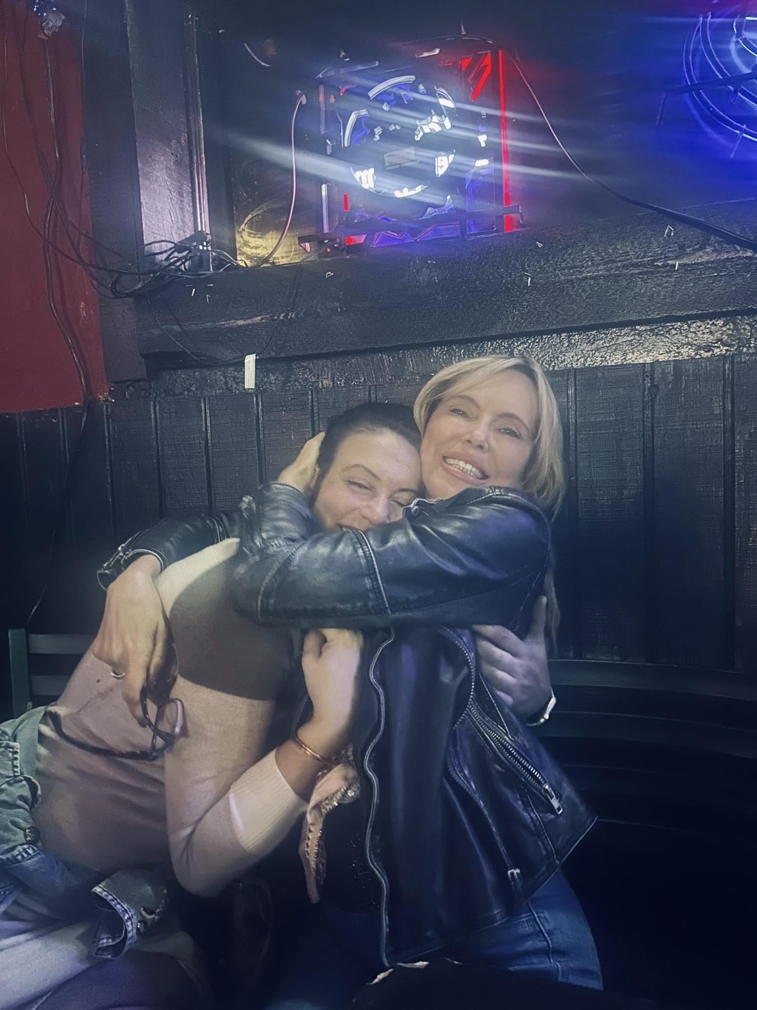 Two women hugging each other