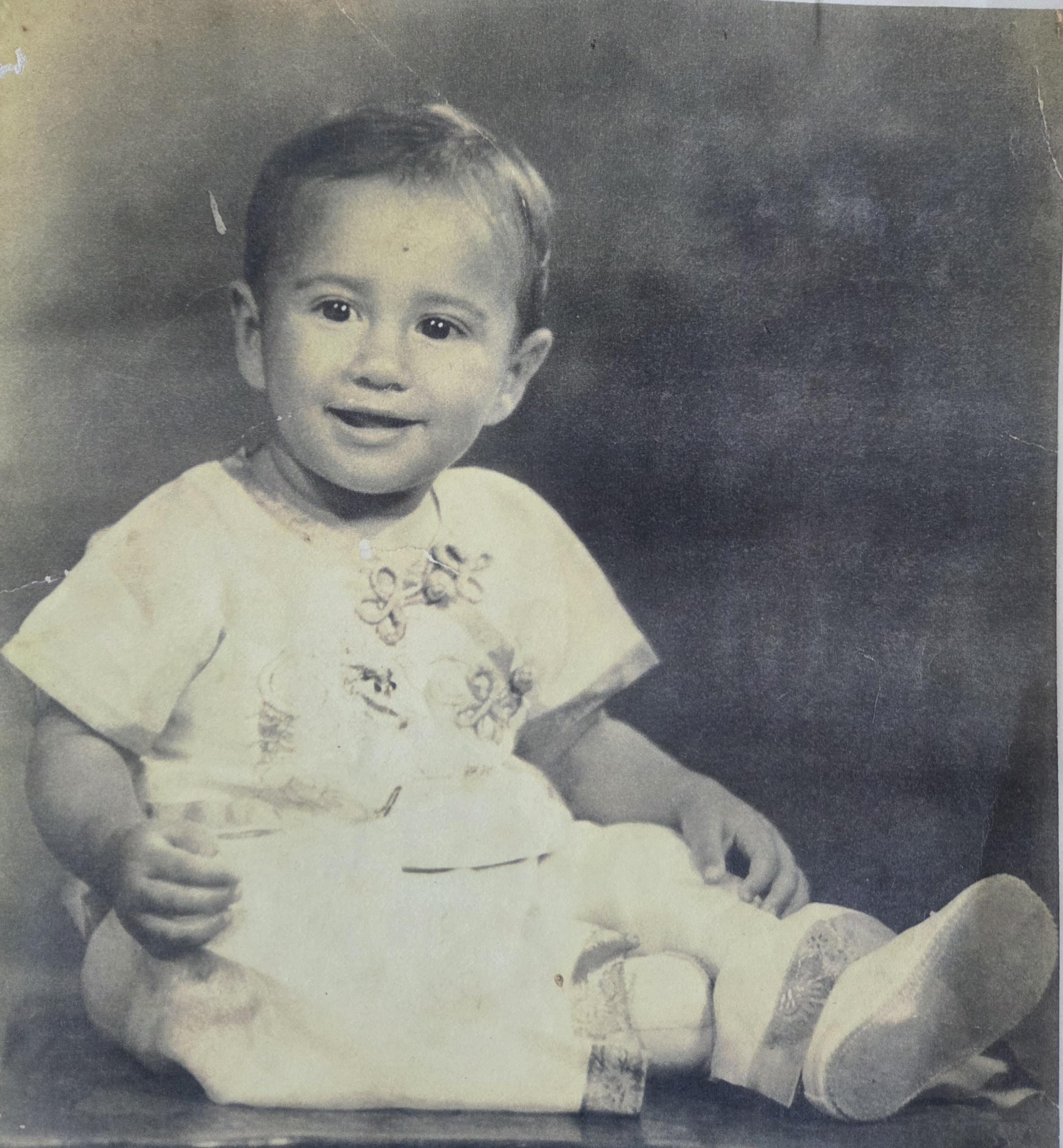 A baby sitting on the floor