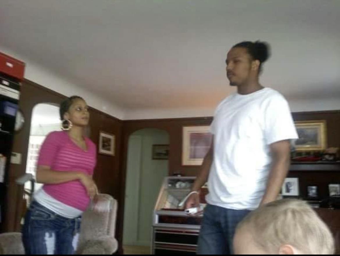 A man and woman standing in a living room