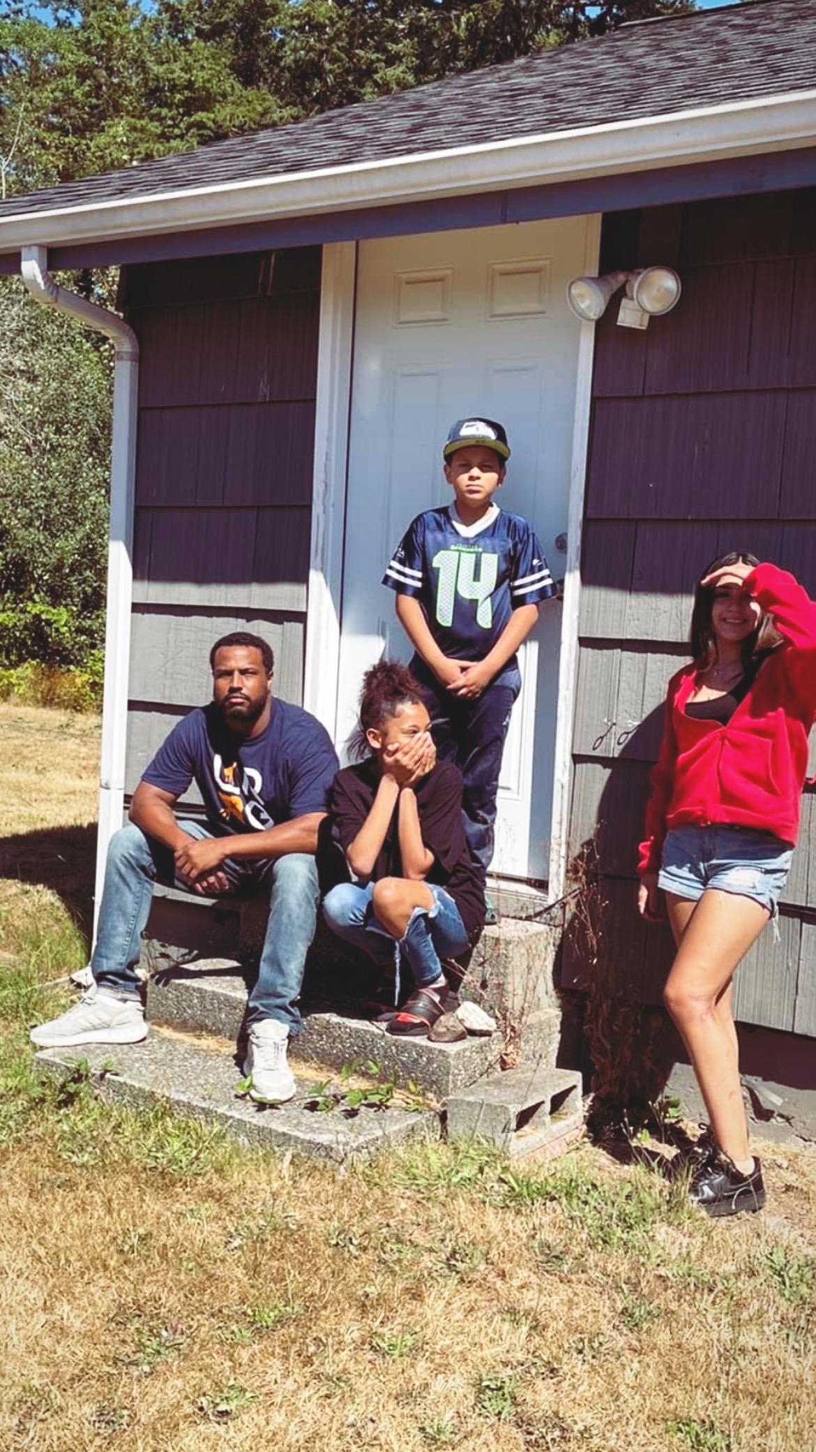 A group of people sitting on a porch