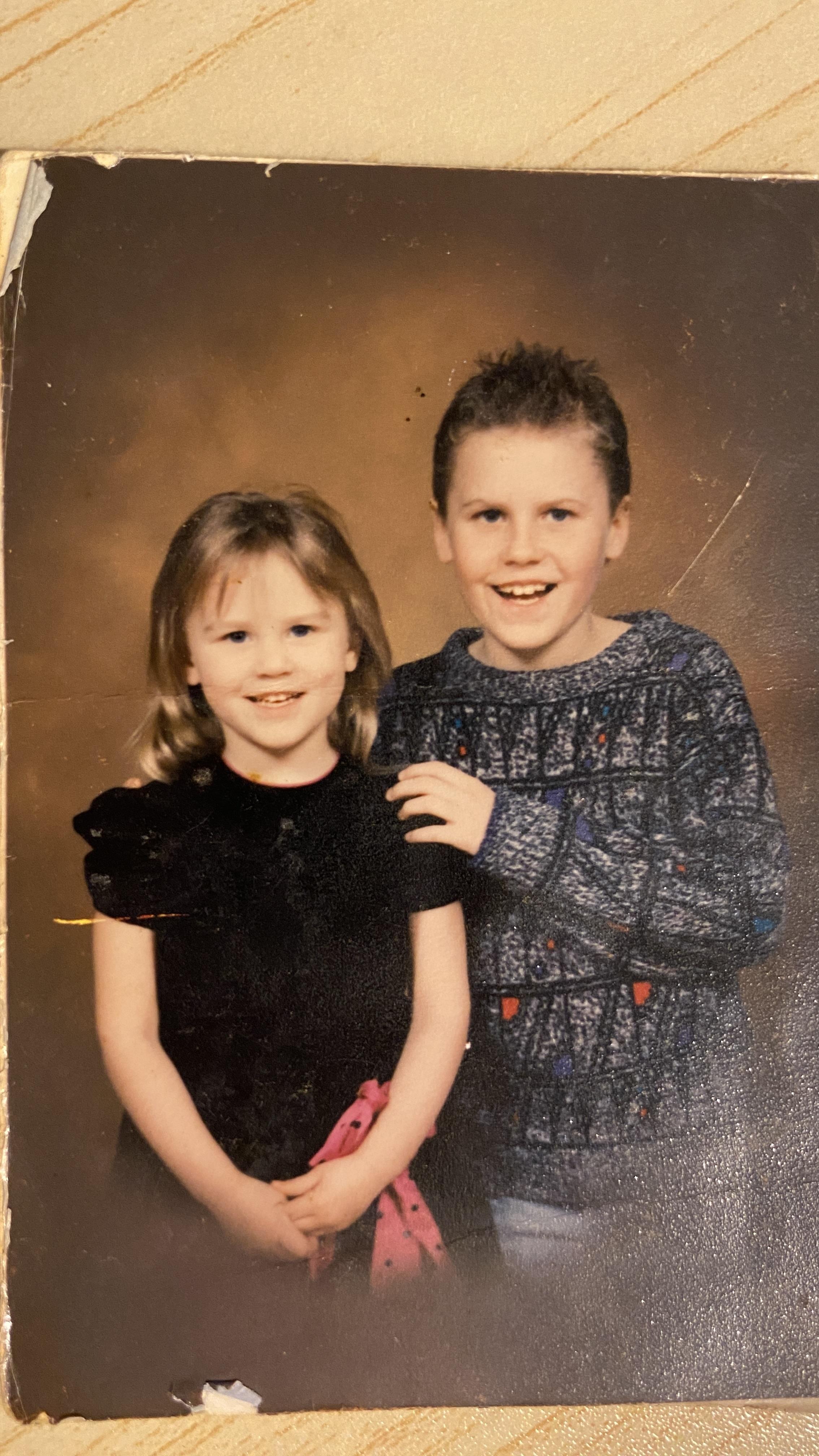 A boy and girl posing for a picture