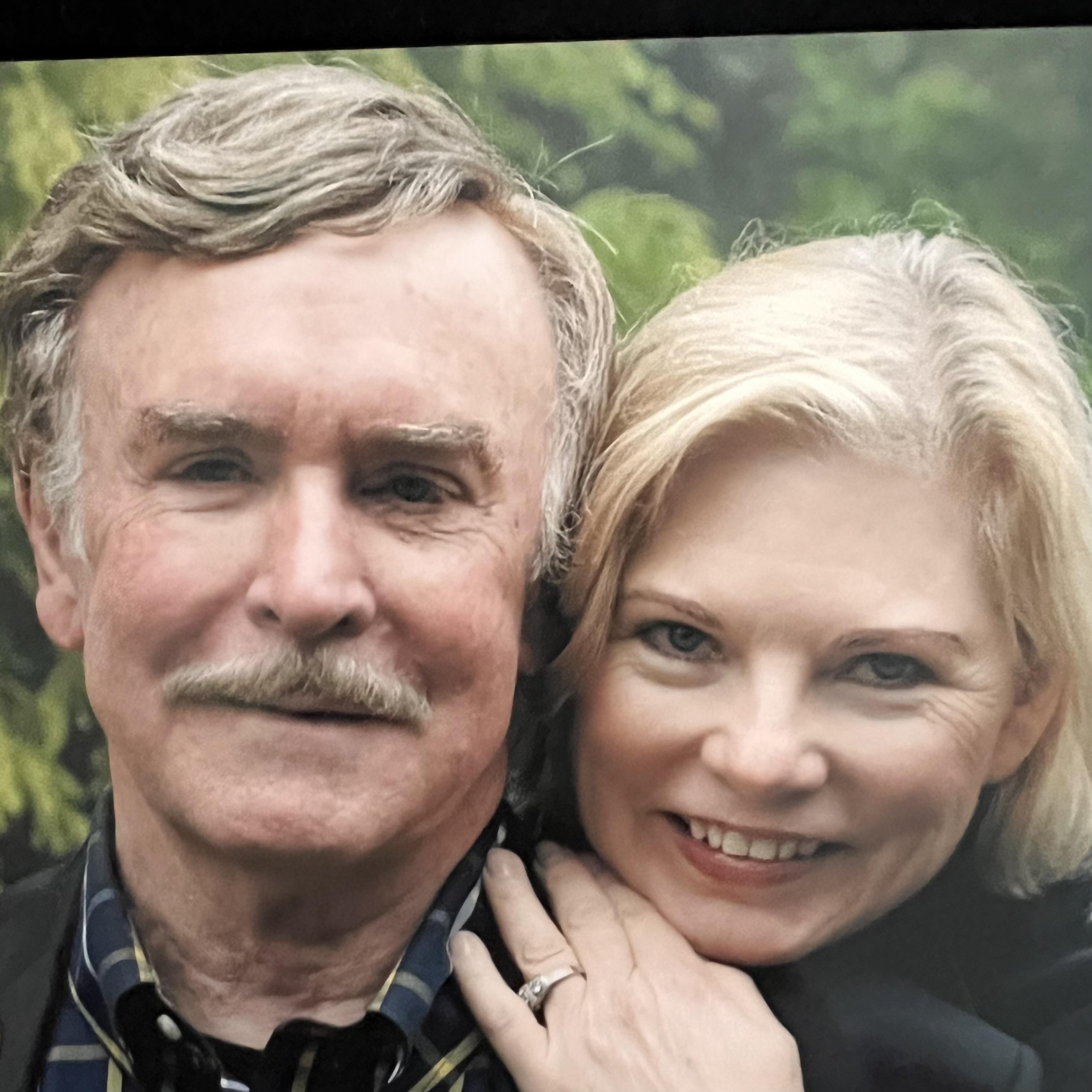 A man and woman posing for a picture