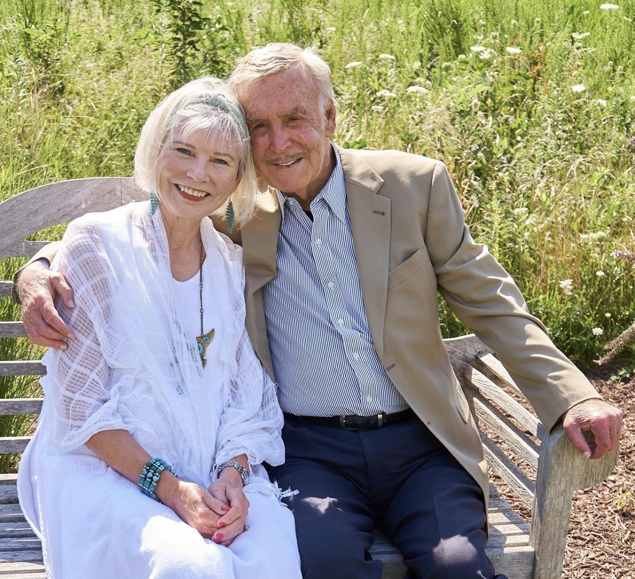 A man and woman sitting on a bench