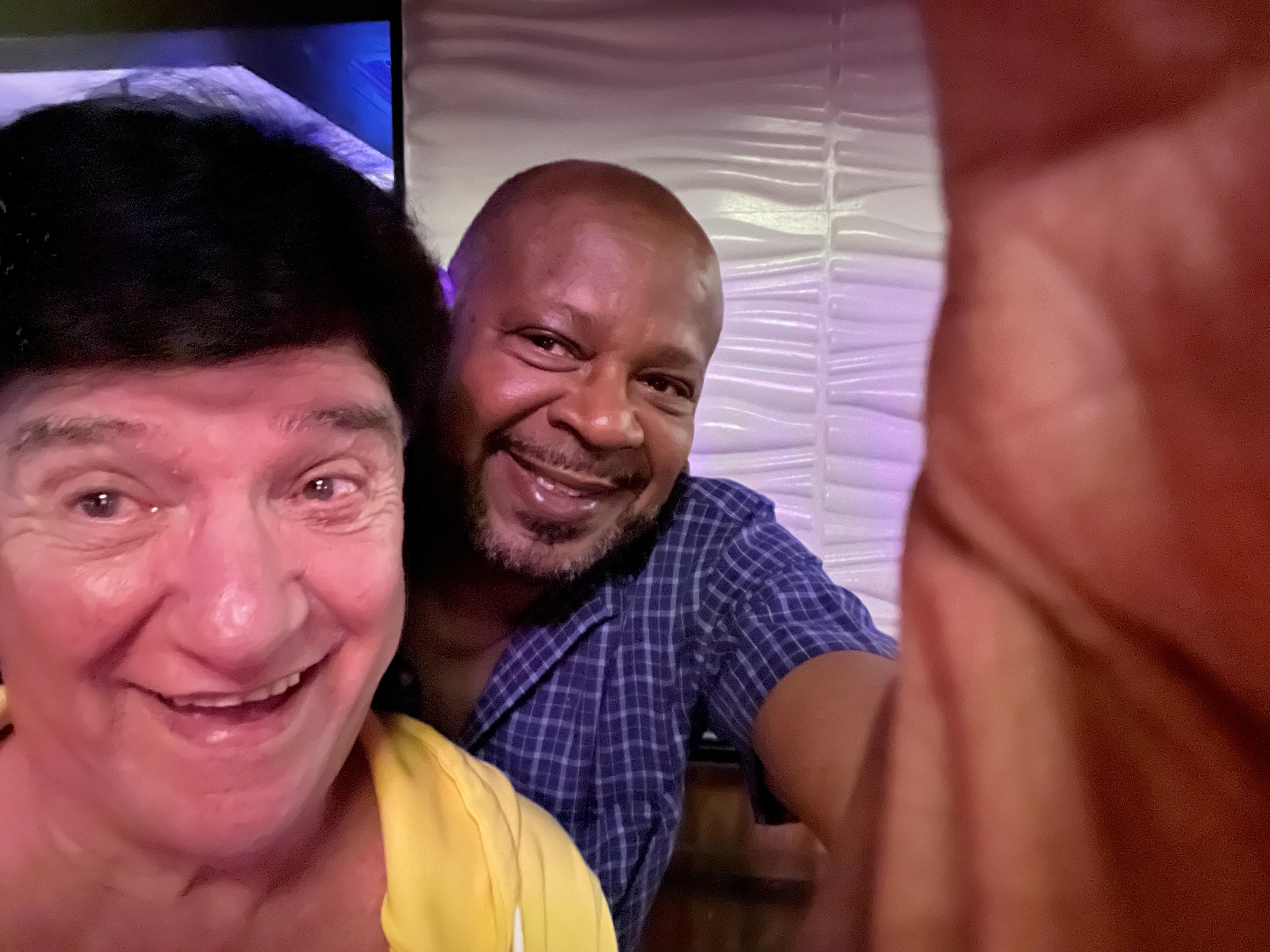 A man taking a selfie with another man