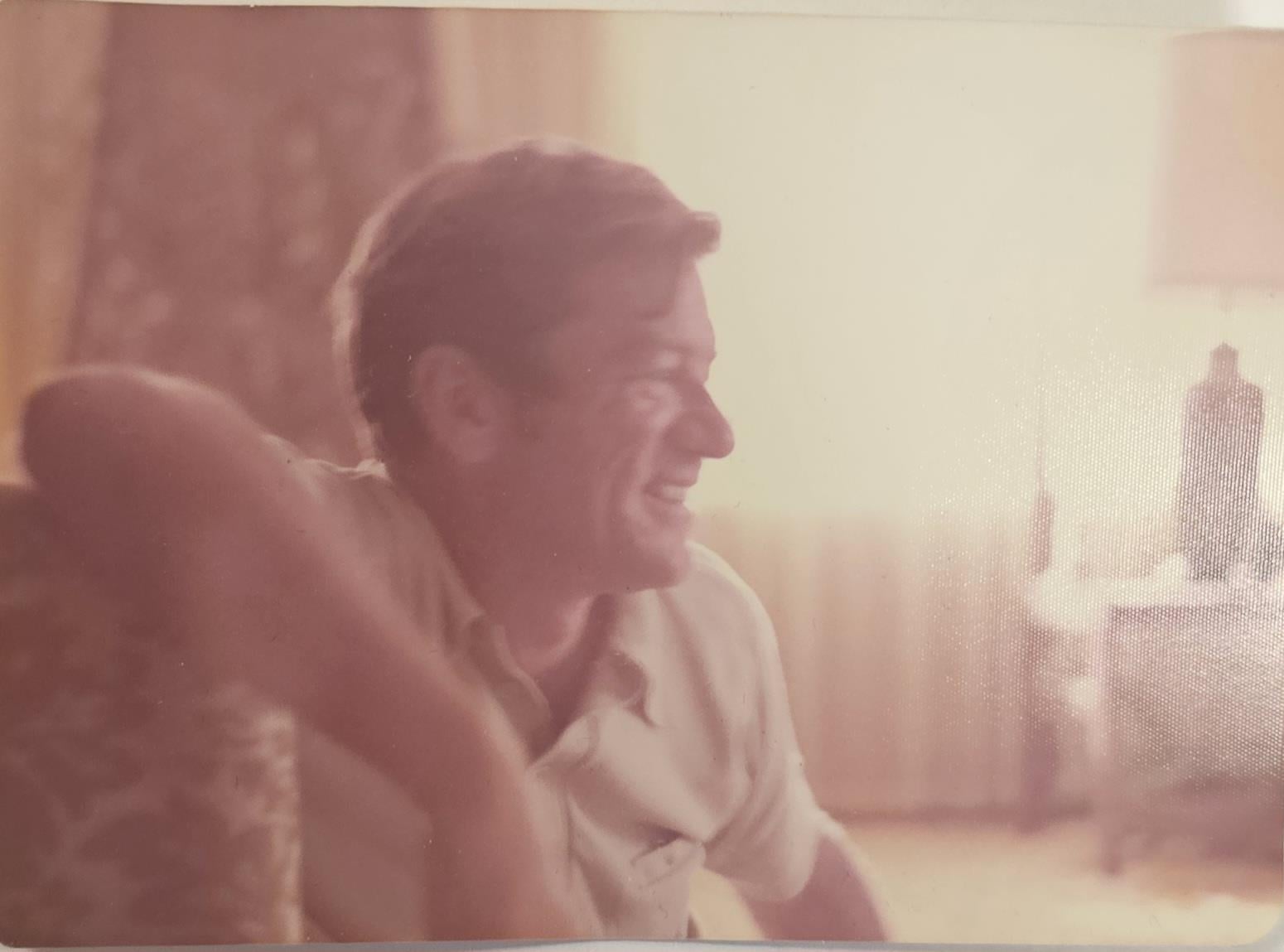 A man smiling and looking away