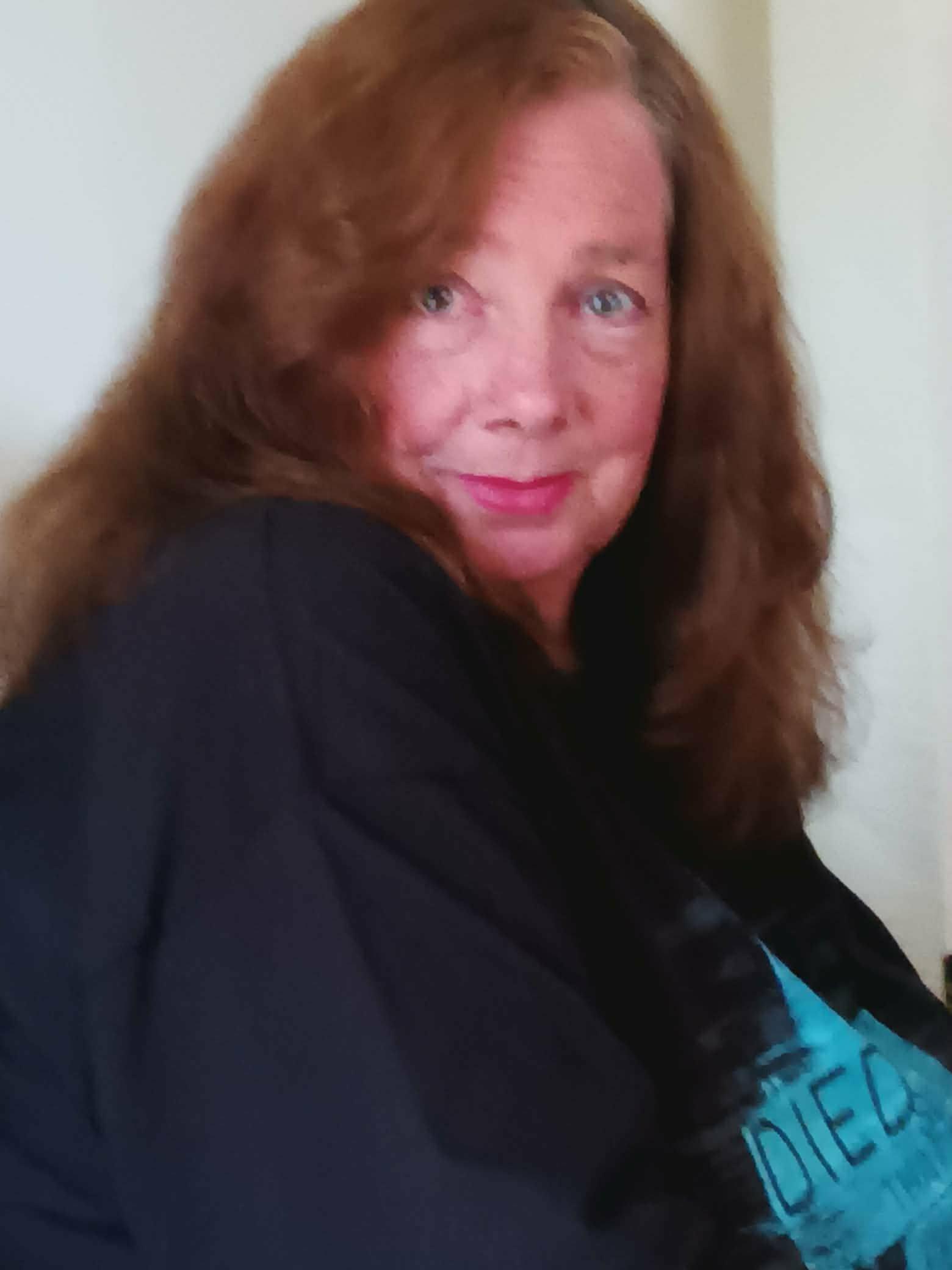 A woman with long hair smiling