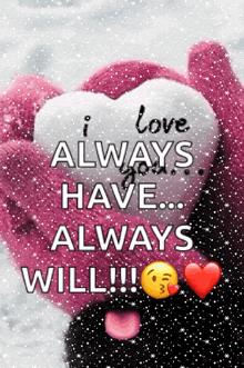A pink gloved hand holding a heart