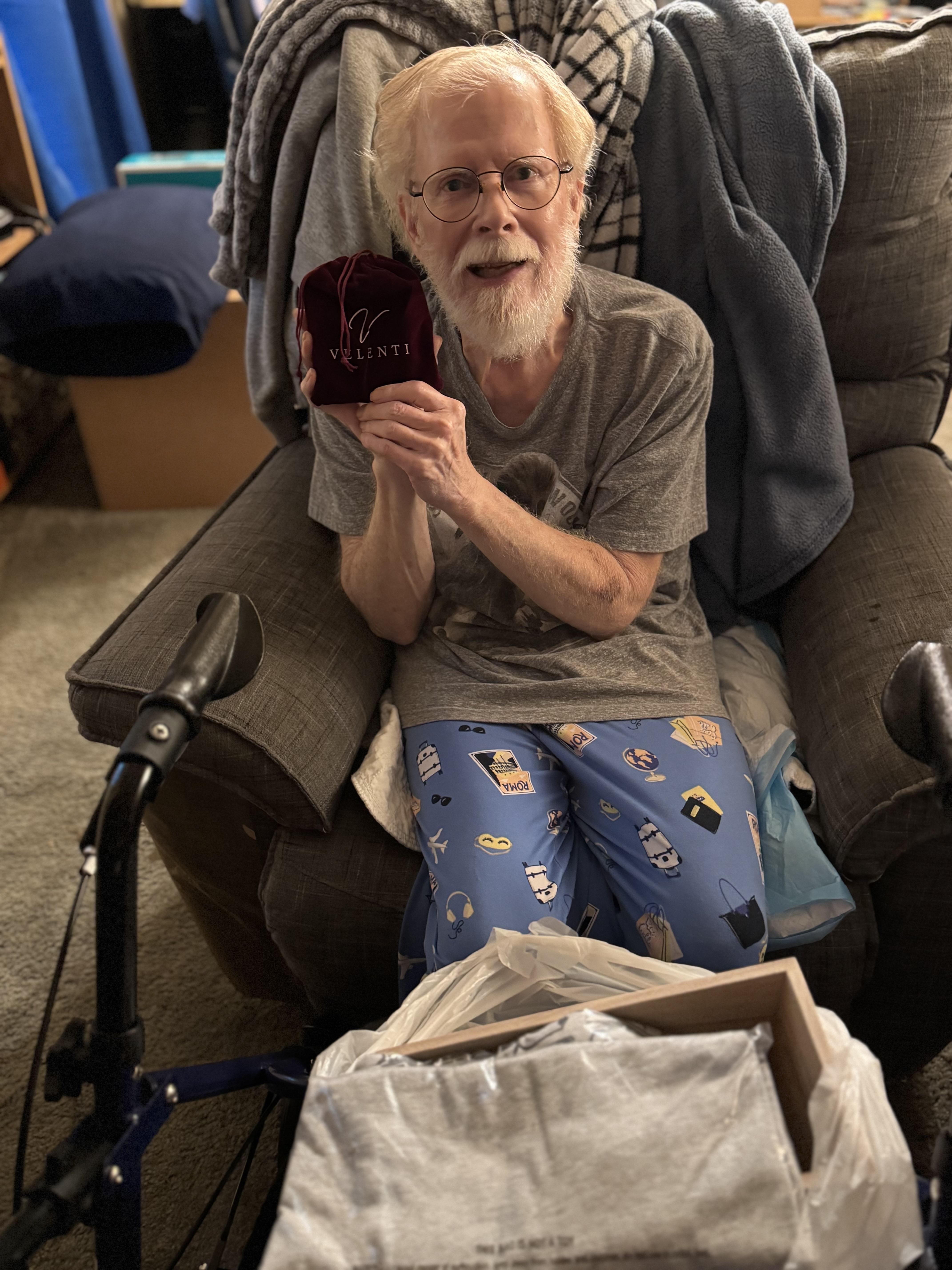 An old man holding a box