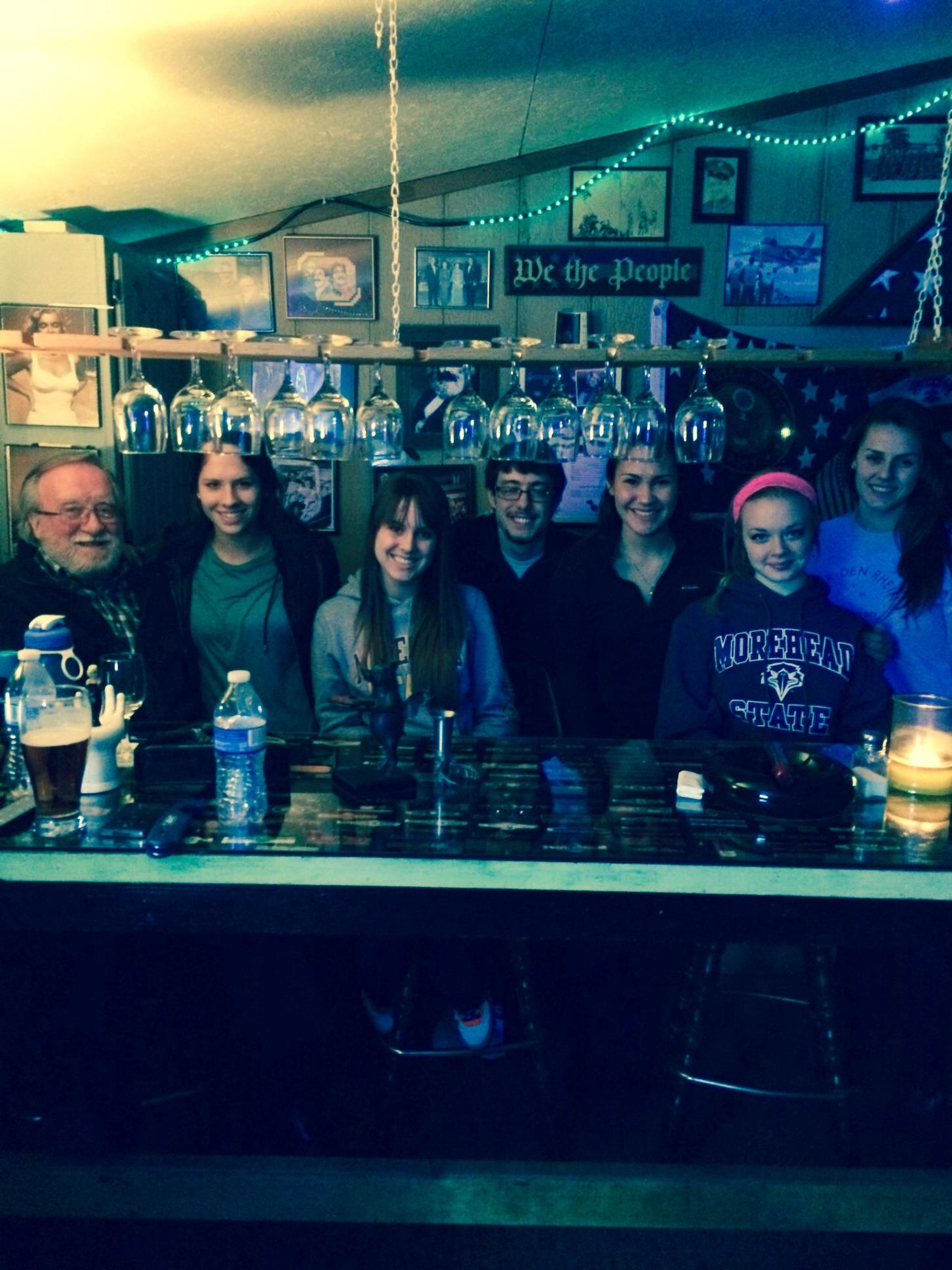 A group of people sitting at a bar