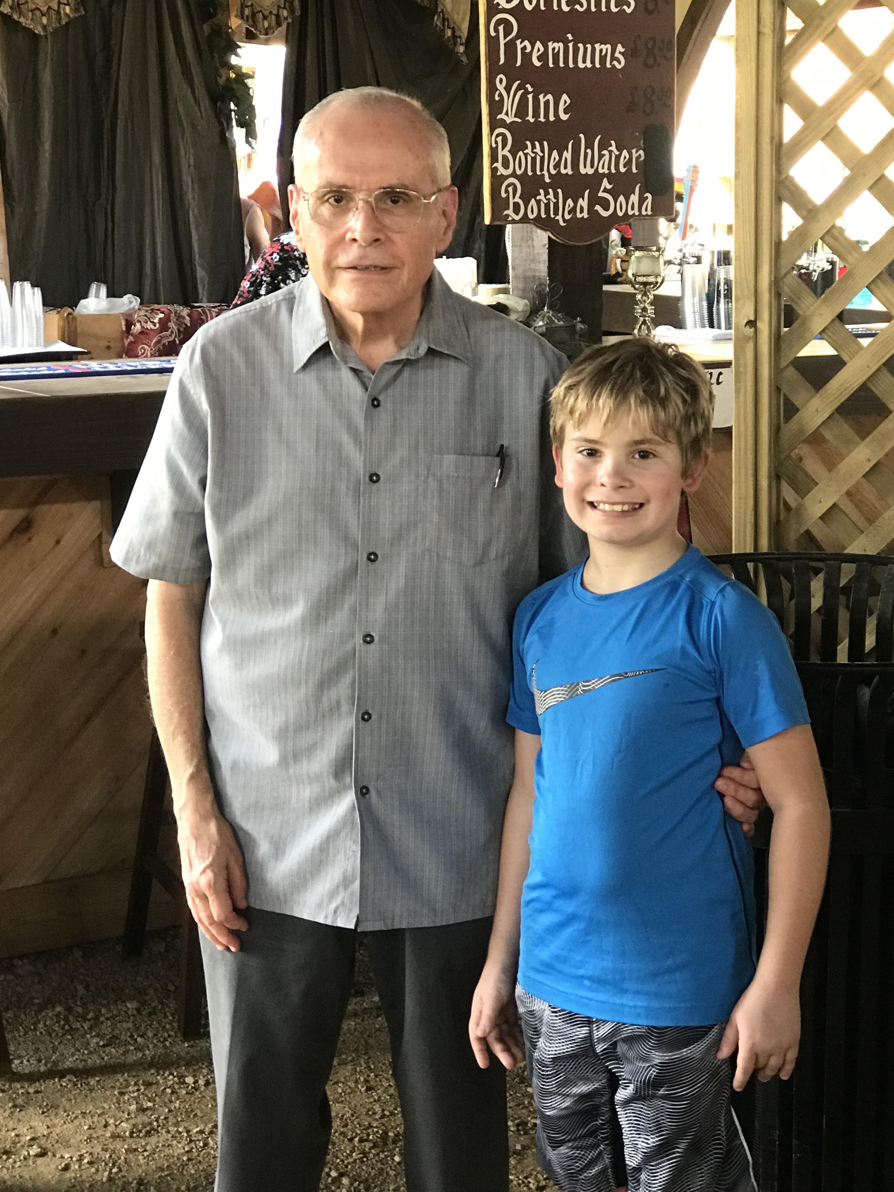 A man and boy standing next to each other