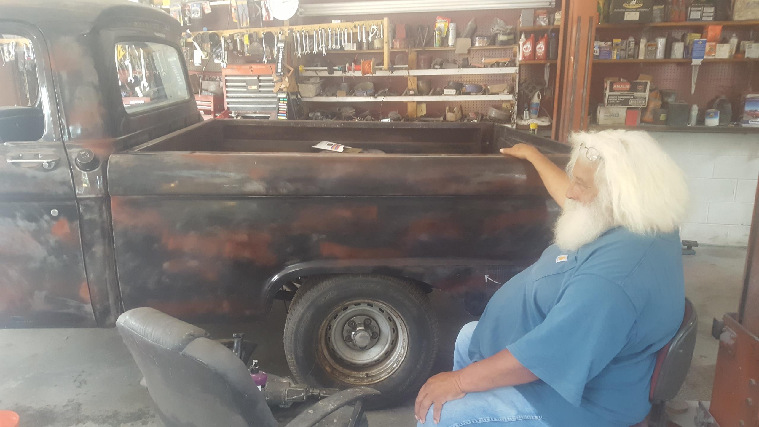 A man sitting in front of a truck