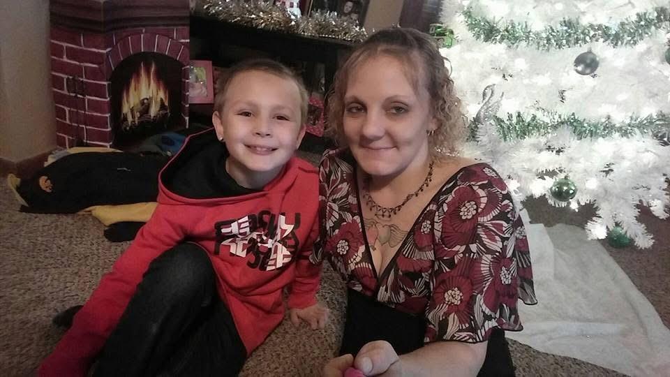 A woman and a boy sitting on the floor