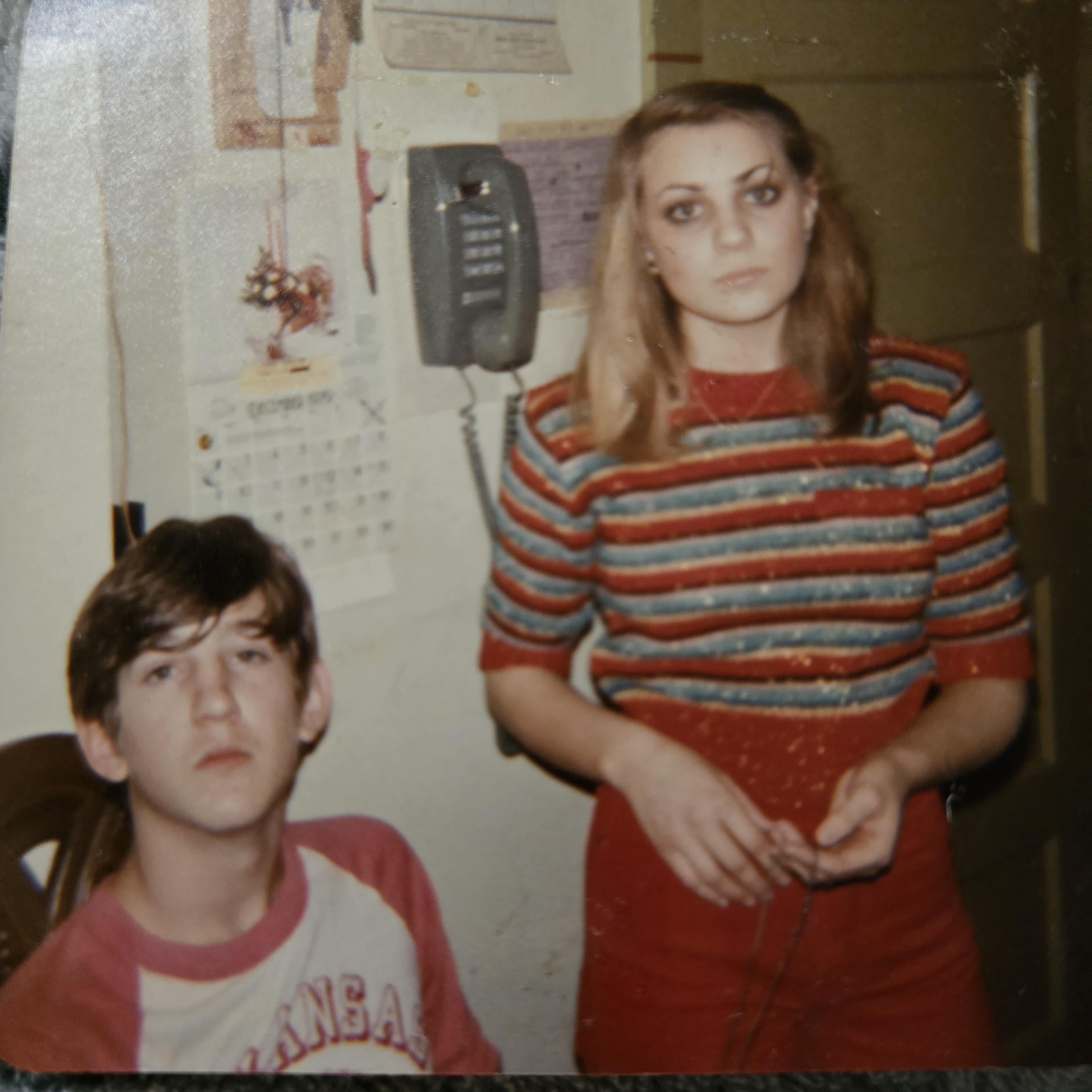 A woman standing next to a boy