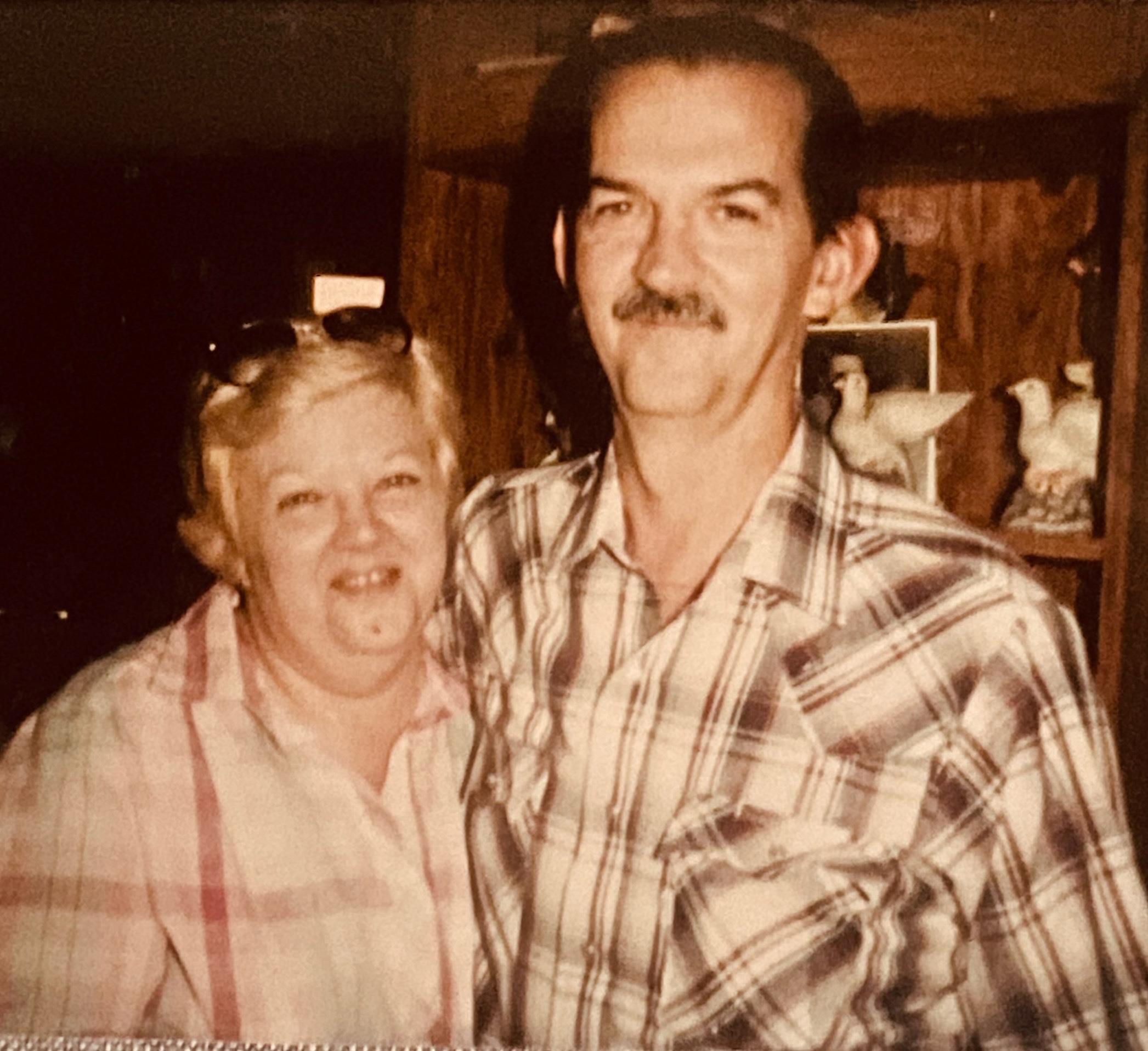 A man and woman posing for a picture