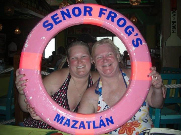A couple of women holding a pink float