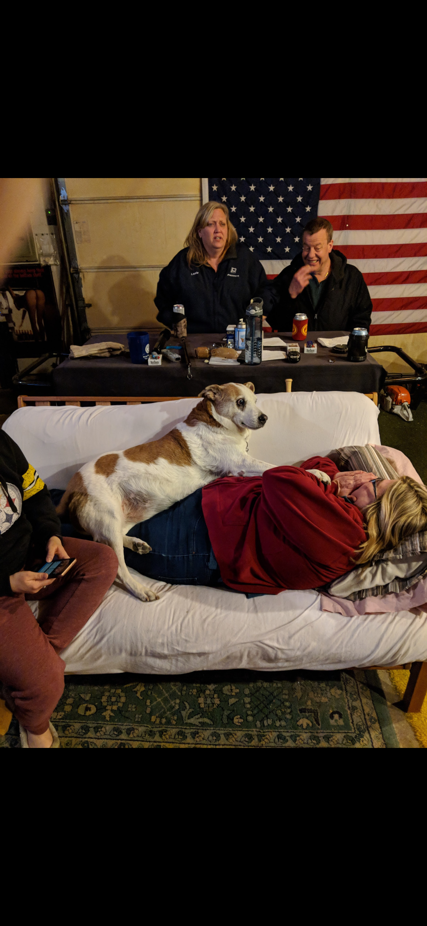 A dog lying on a woman's back