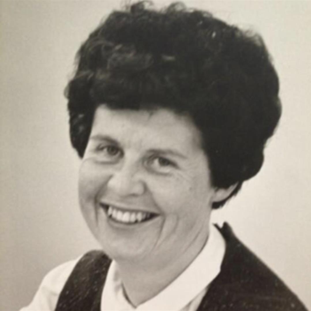 A woman with short hair smiling