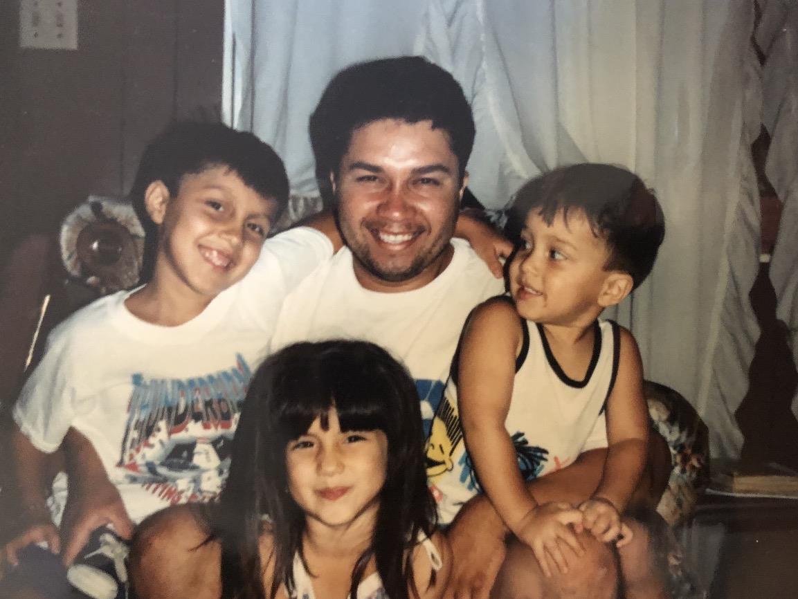 A man and children posing for a picture