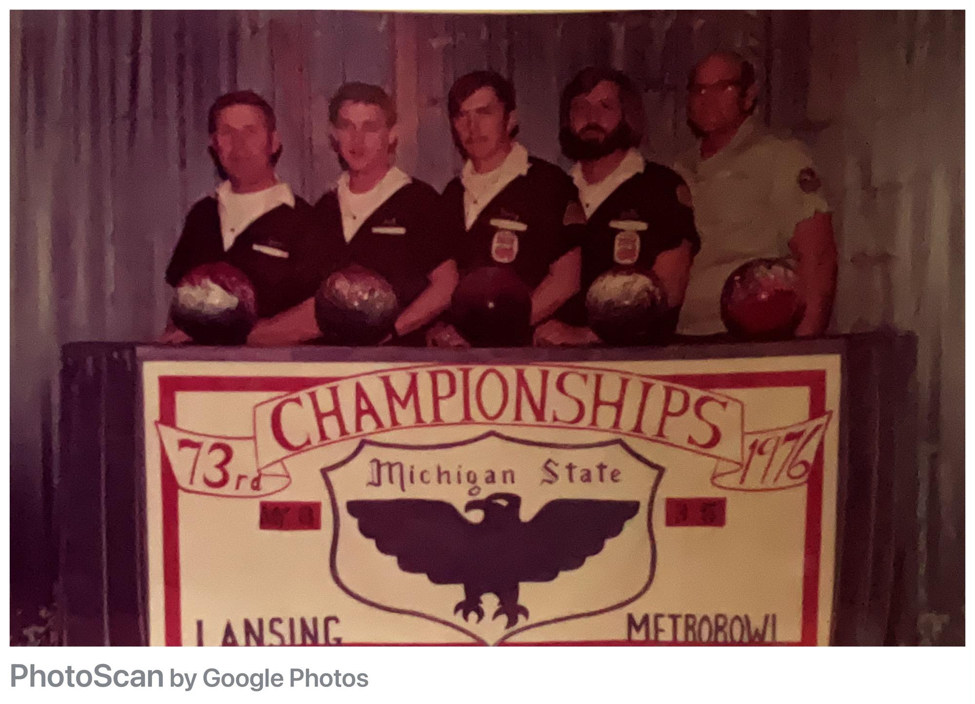 A group of men standing behind a sign