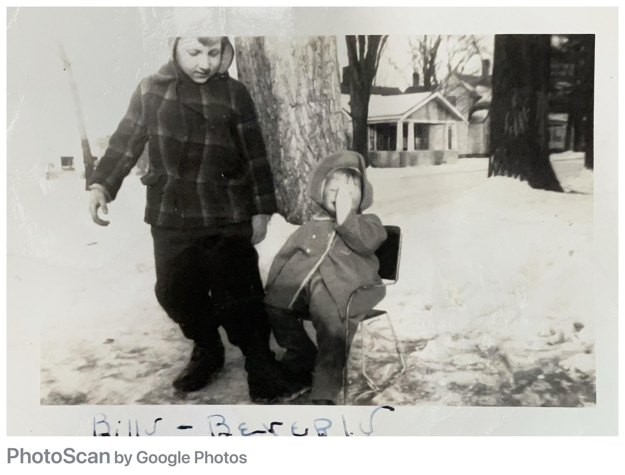 A boy and girl standing in the snow