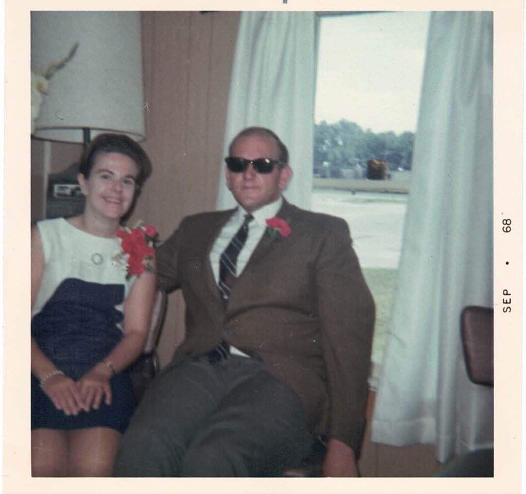 A man and woman sitting in a chair