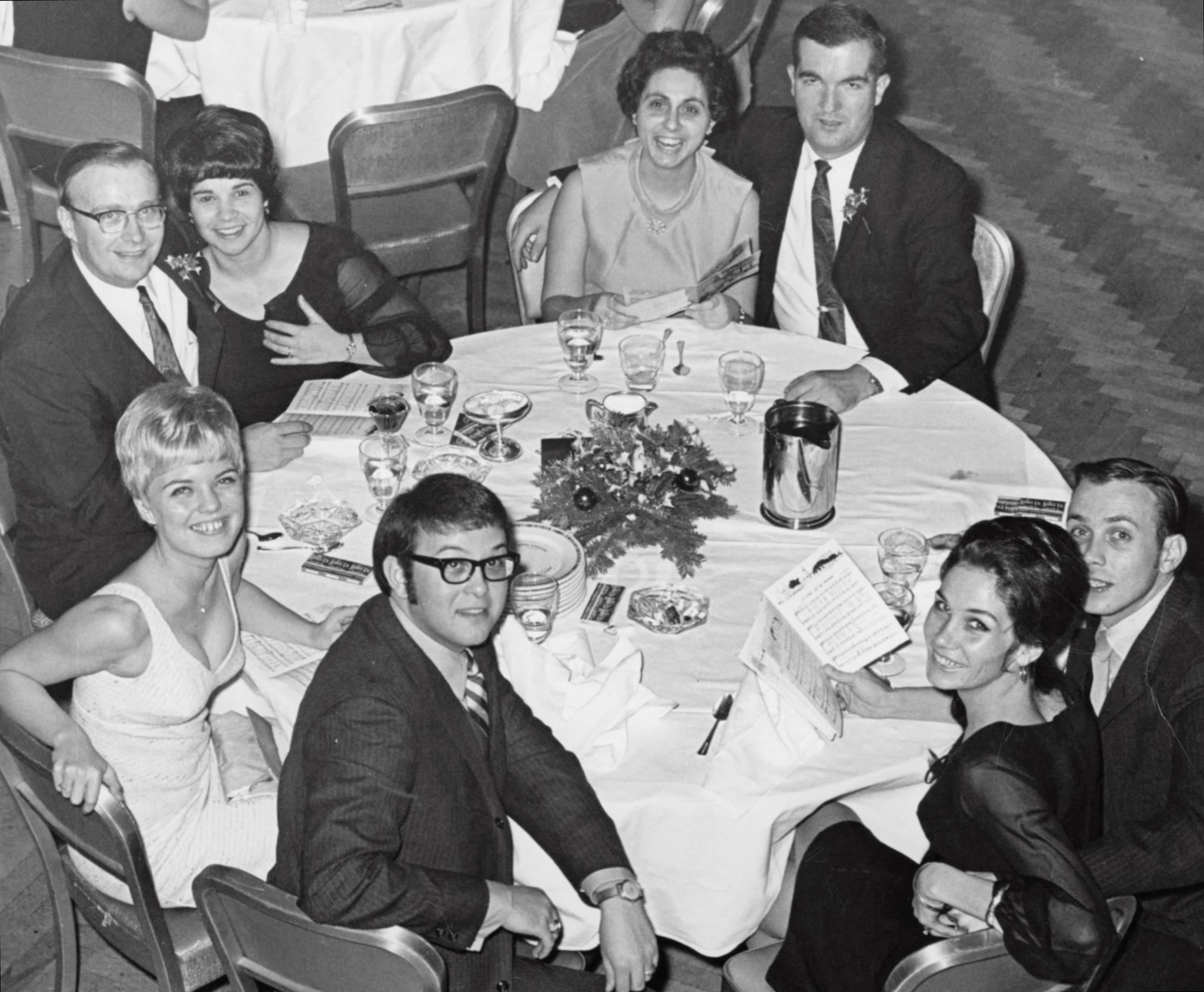 A group of people sitting around a round table