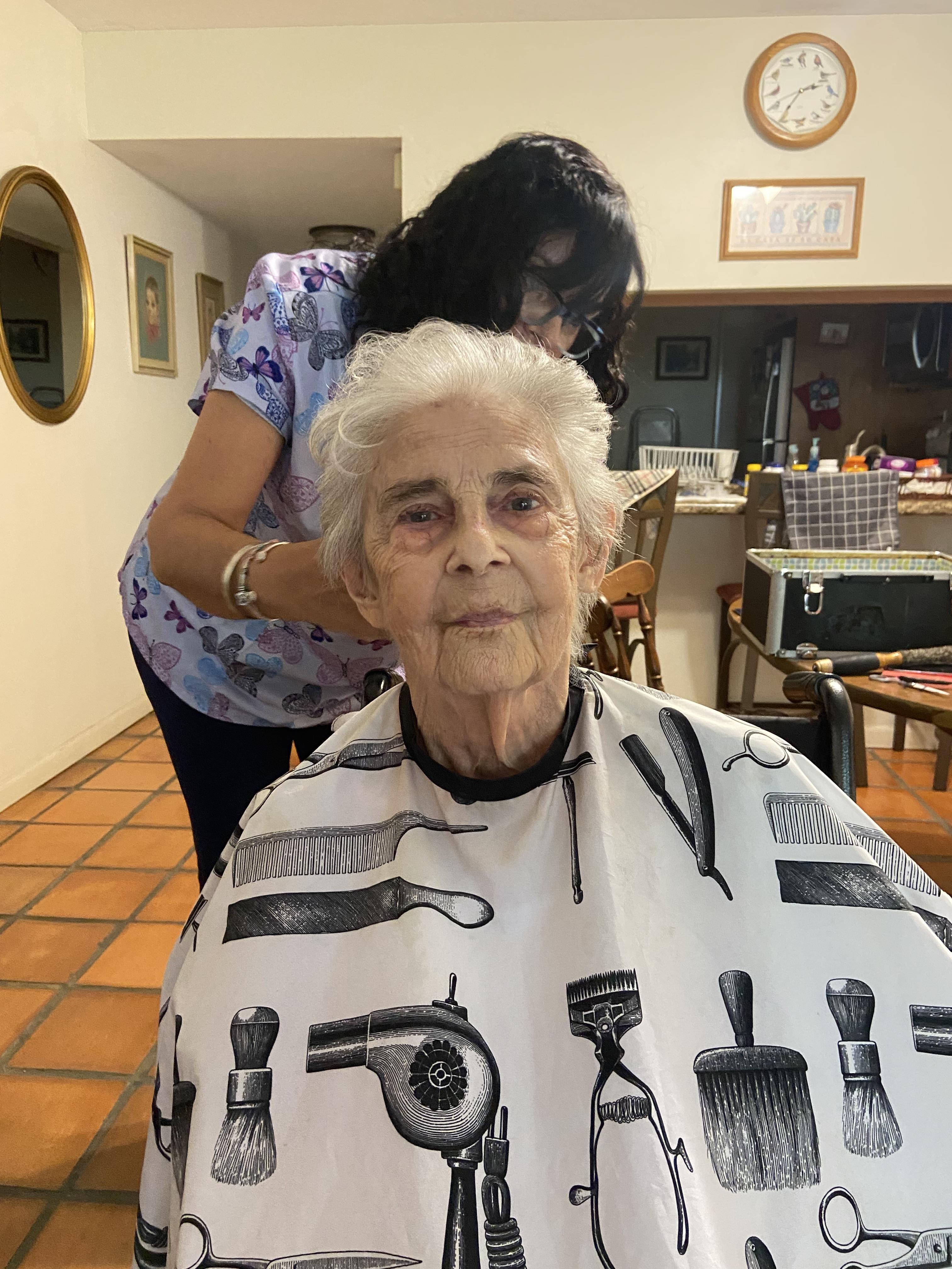 A woman getting her hair cut