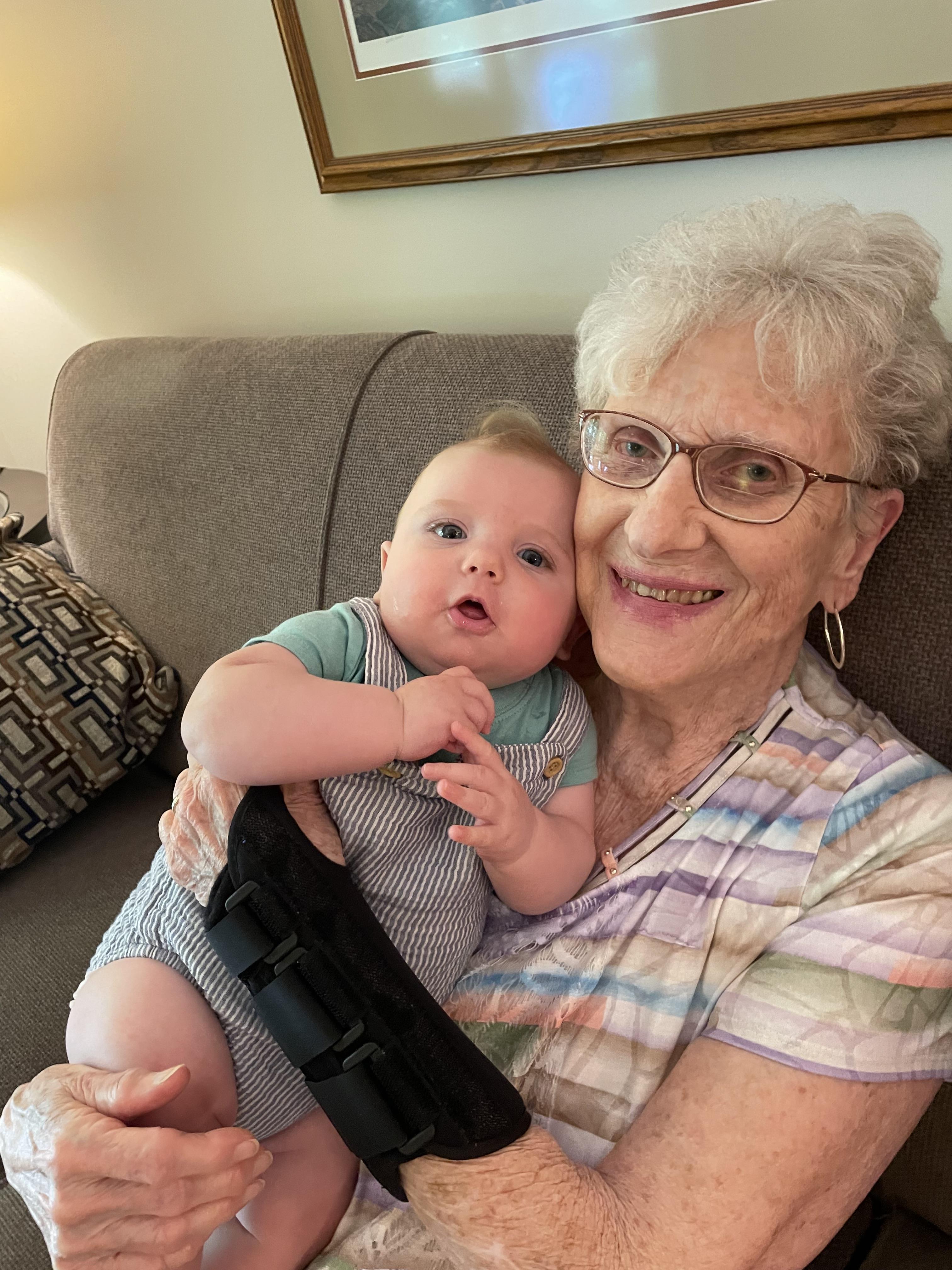 An older woman holding a baby