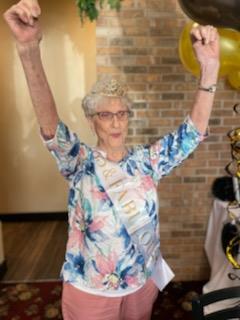 An old woman with her arms up