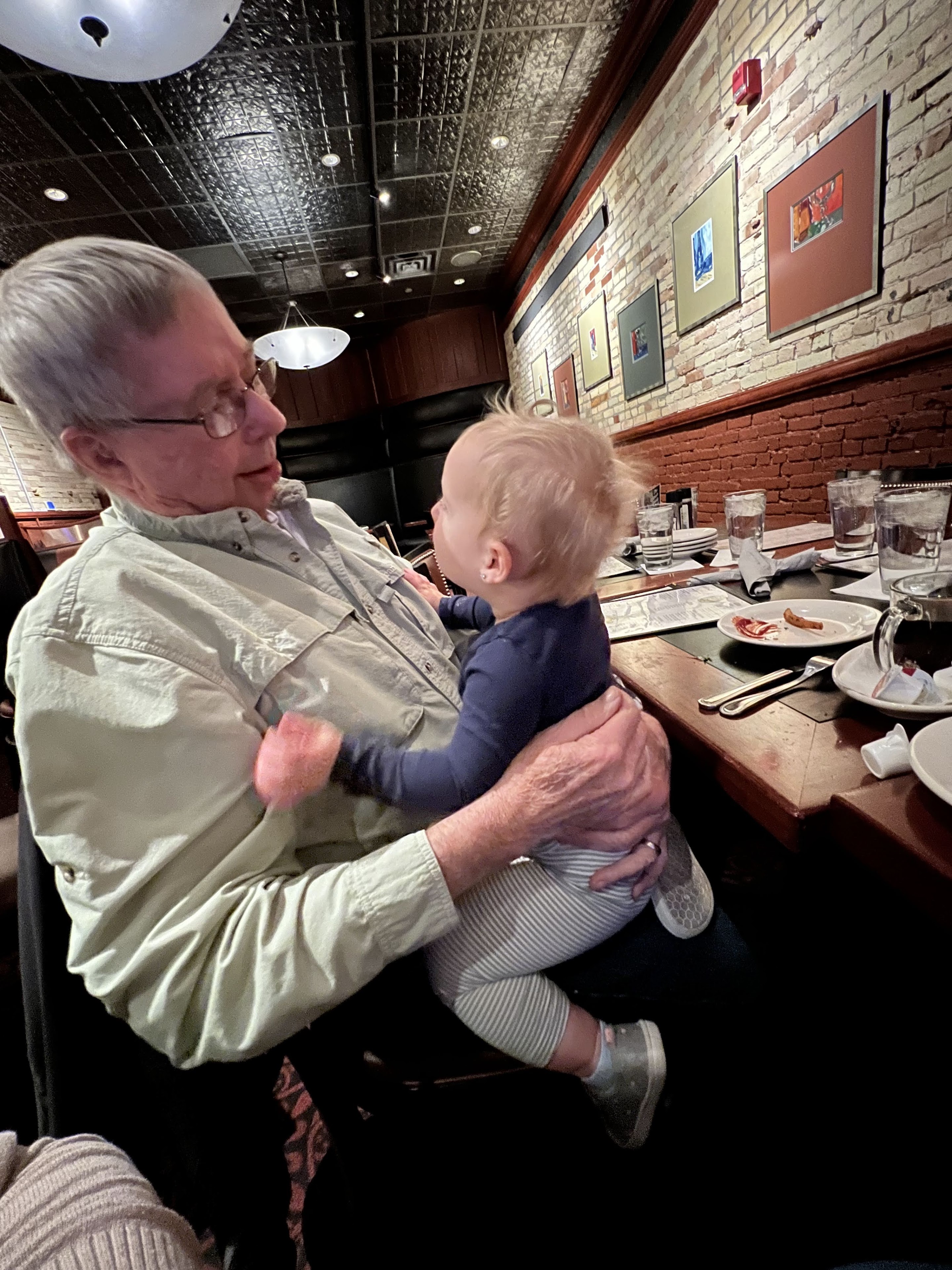 An old man holding a baby