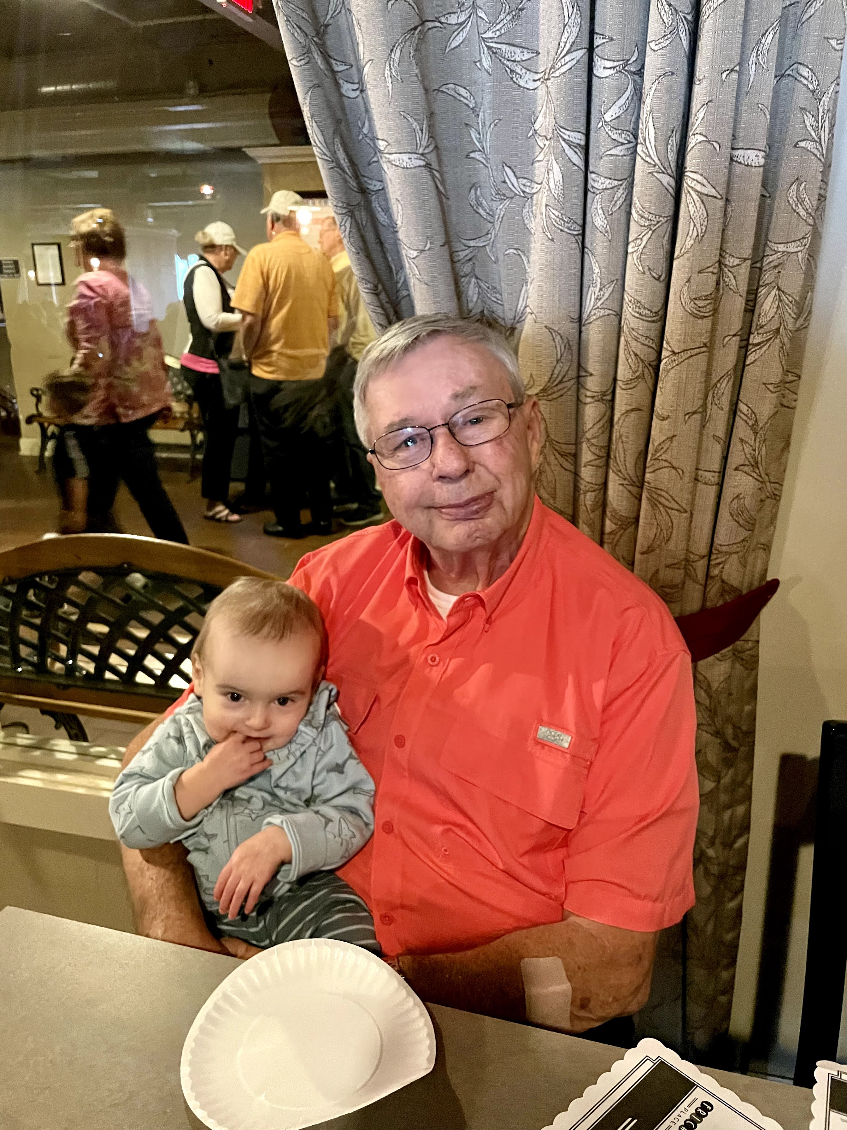 An old man holding a baby