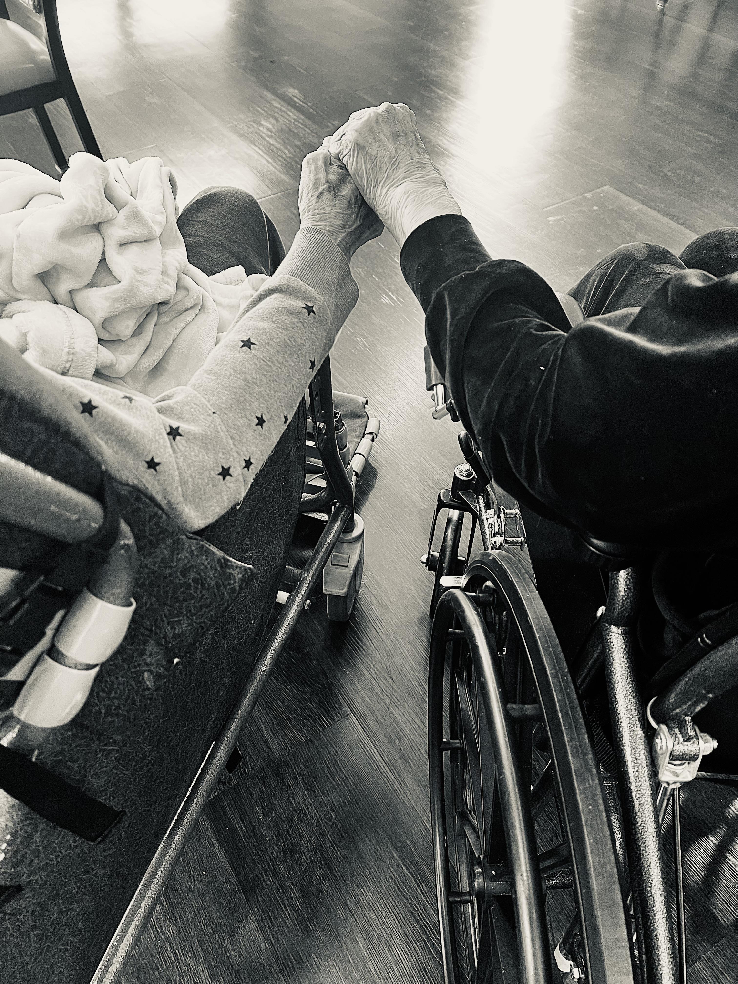 A person in a wheelchair holding their hands
