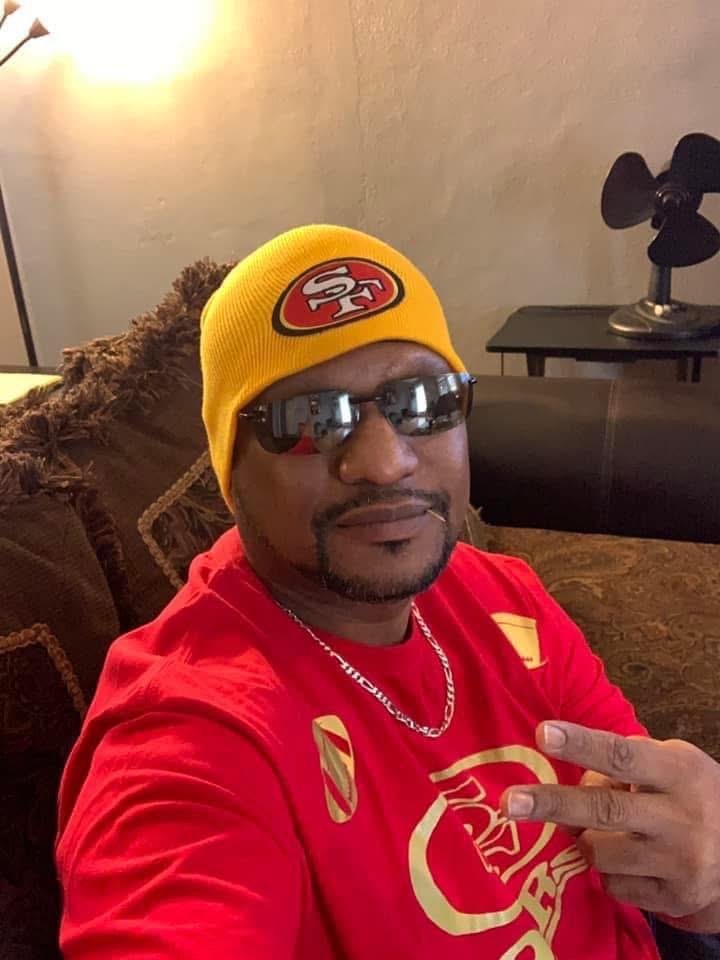 A man wearing a hat and sunglasses
