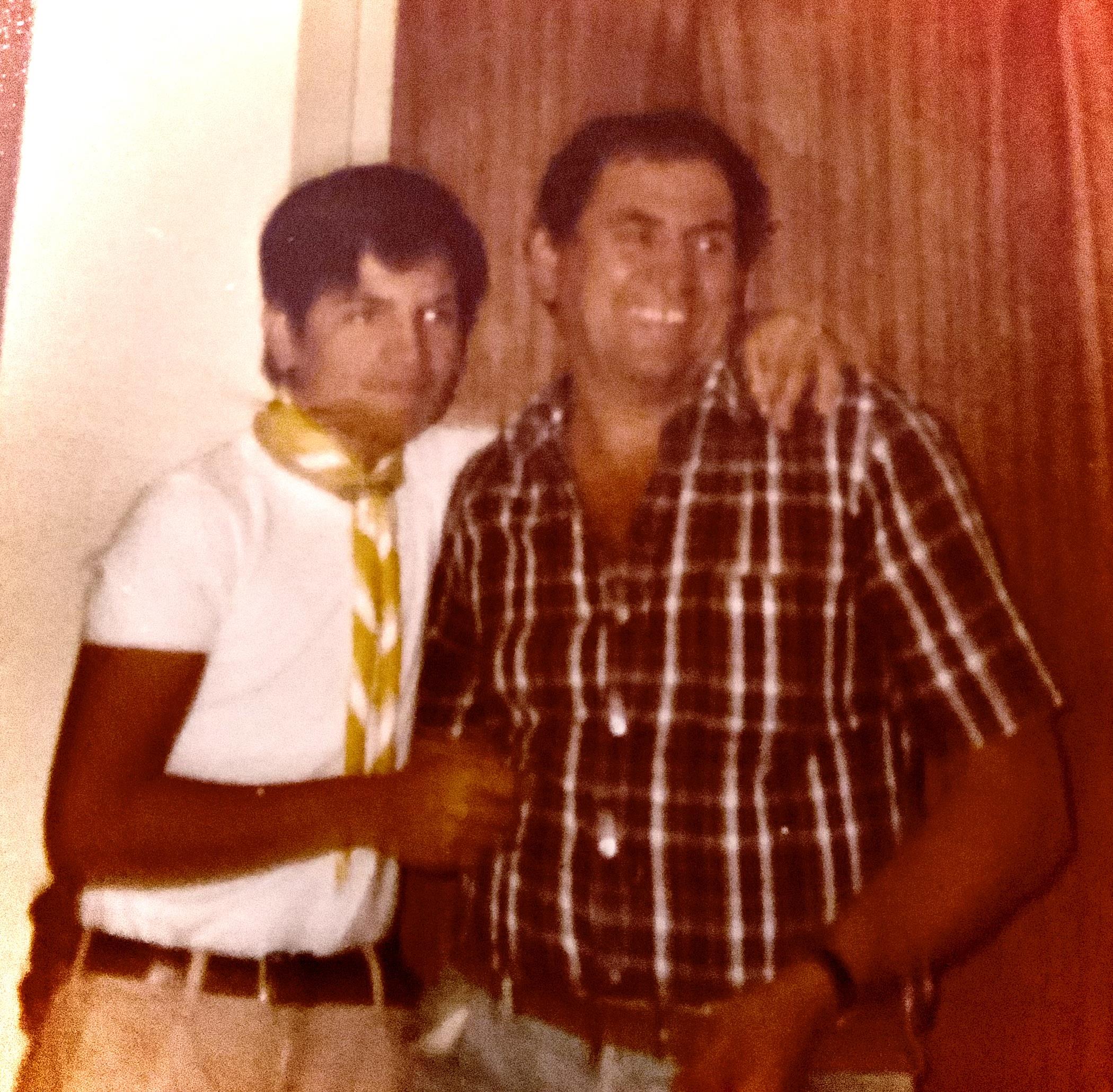 A man standing next to another man