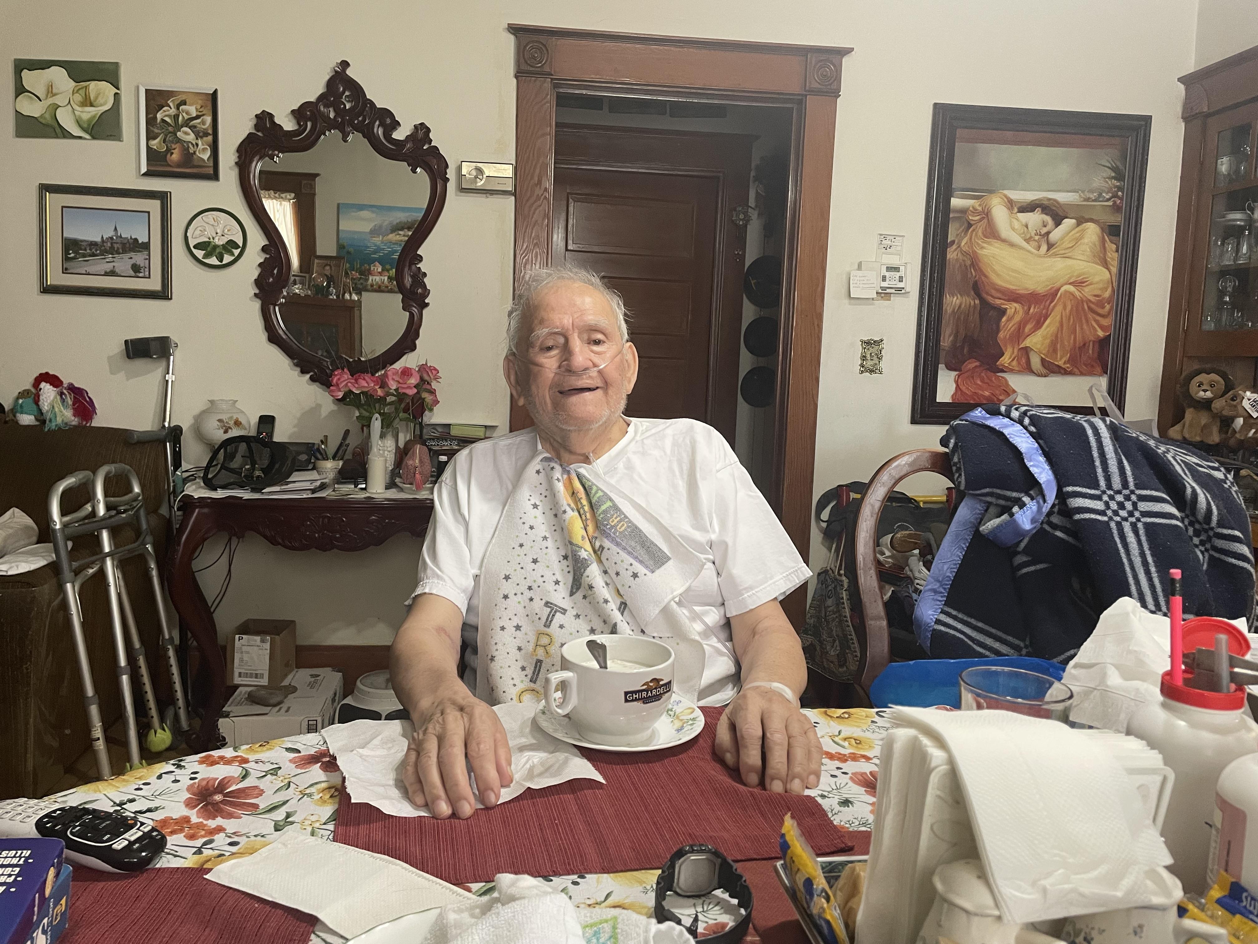 An old man sitting at a table