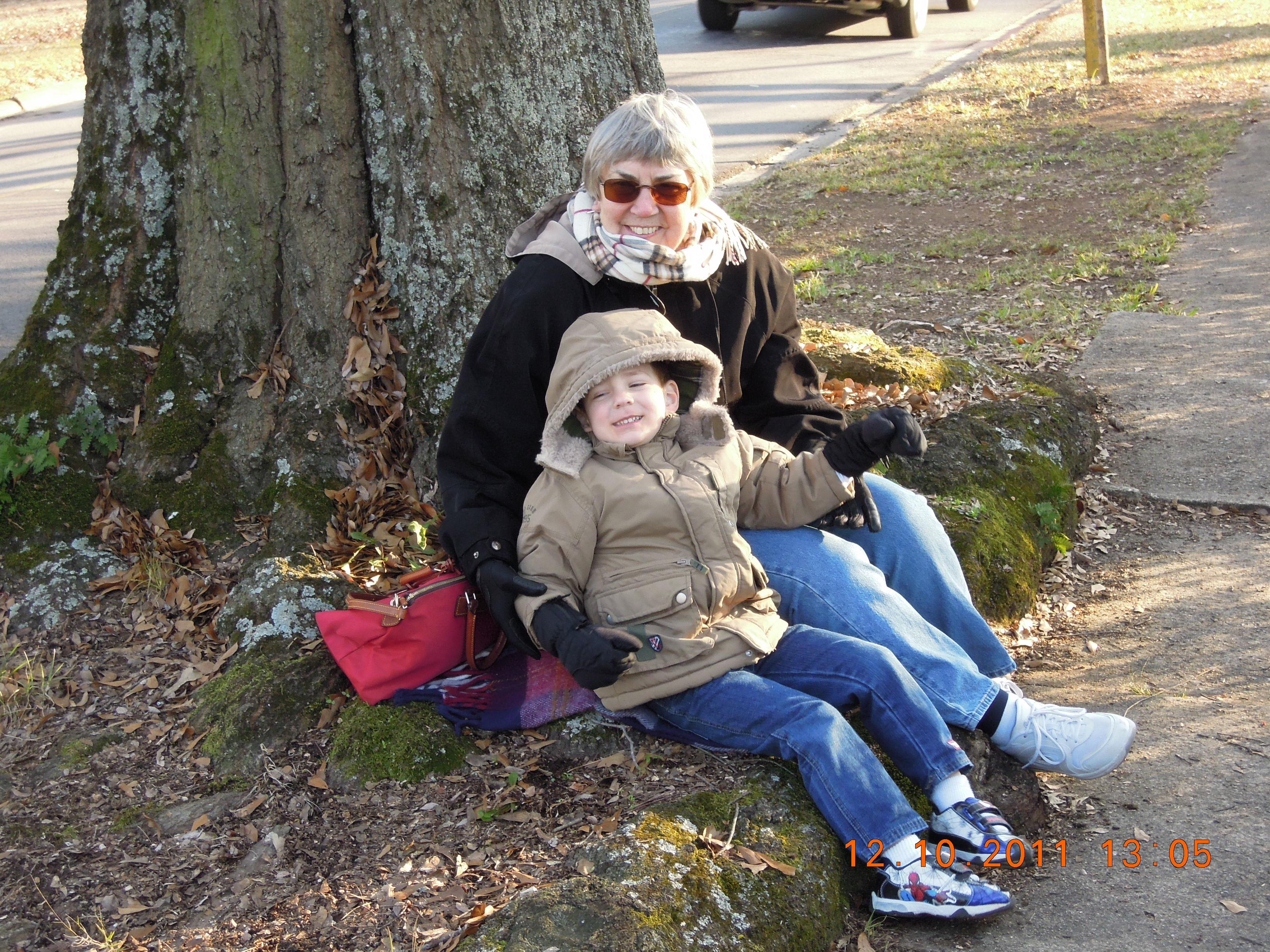 A woman and a child sitting on a rock