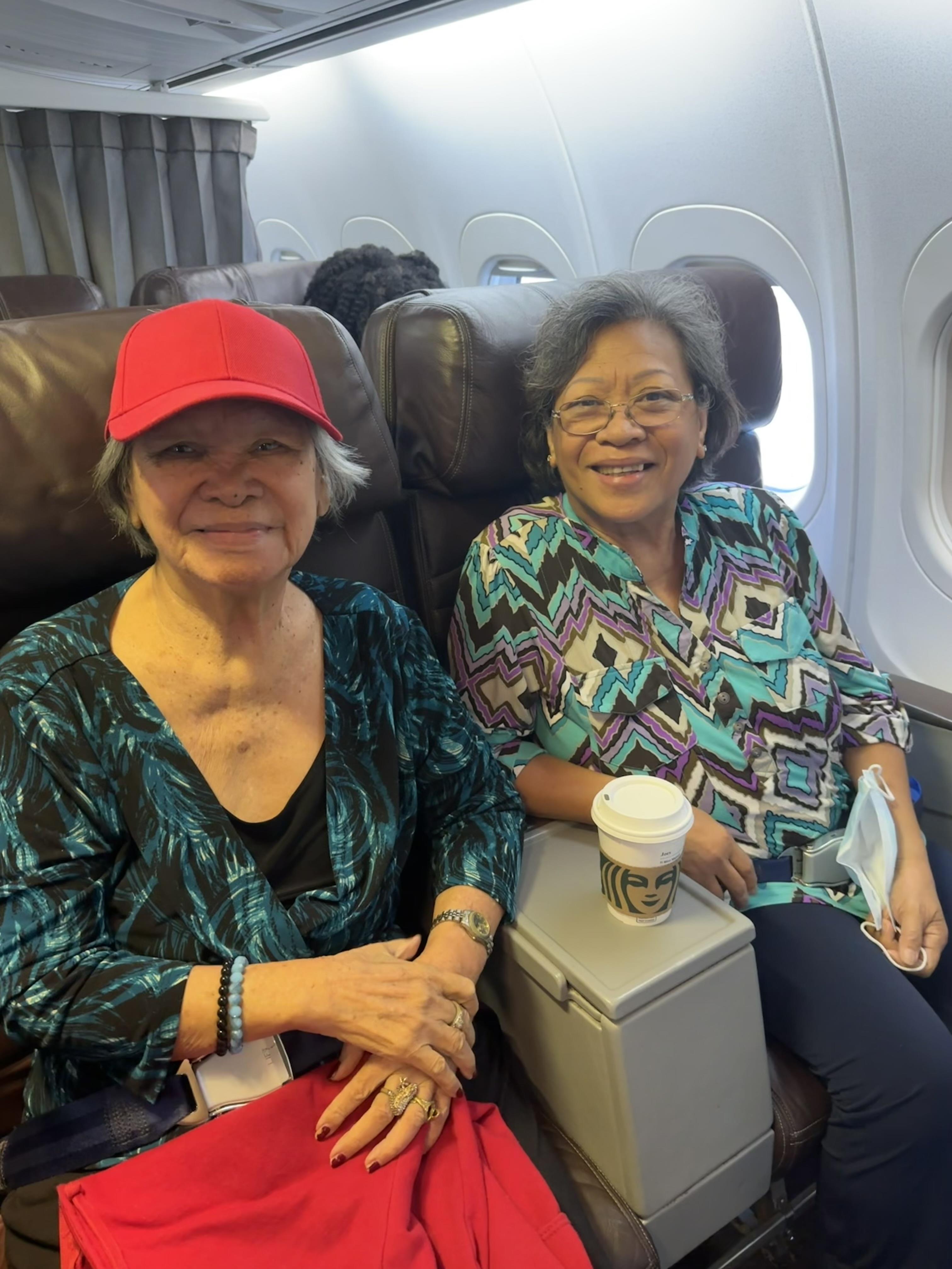 Two women sitting on a plane