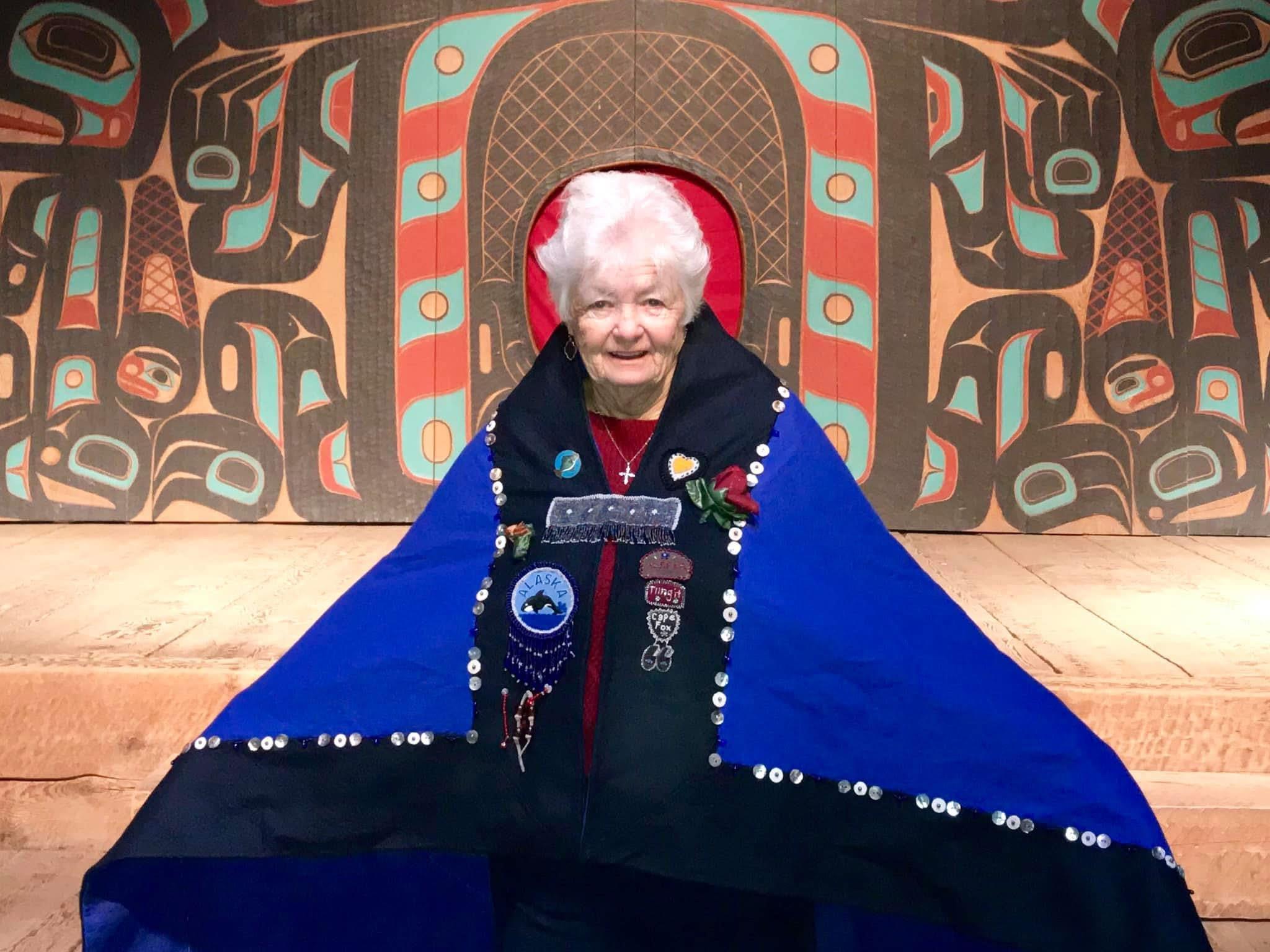 An old woman in a blue cape