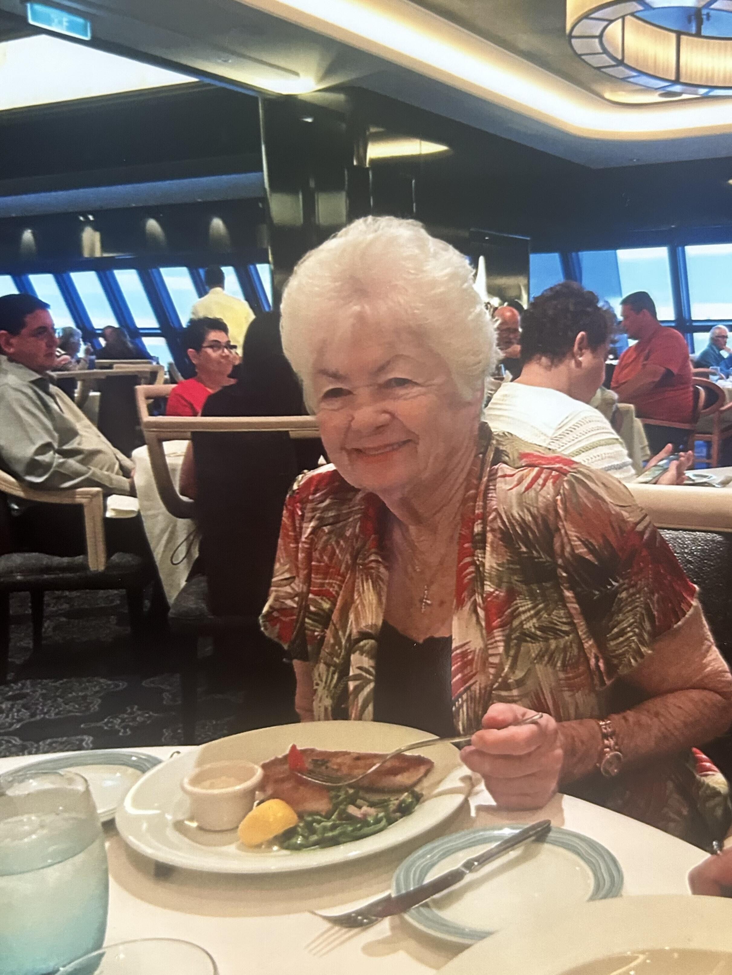 A woman sitting at a table with food