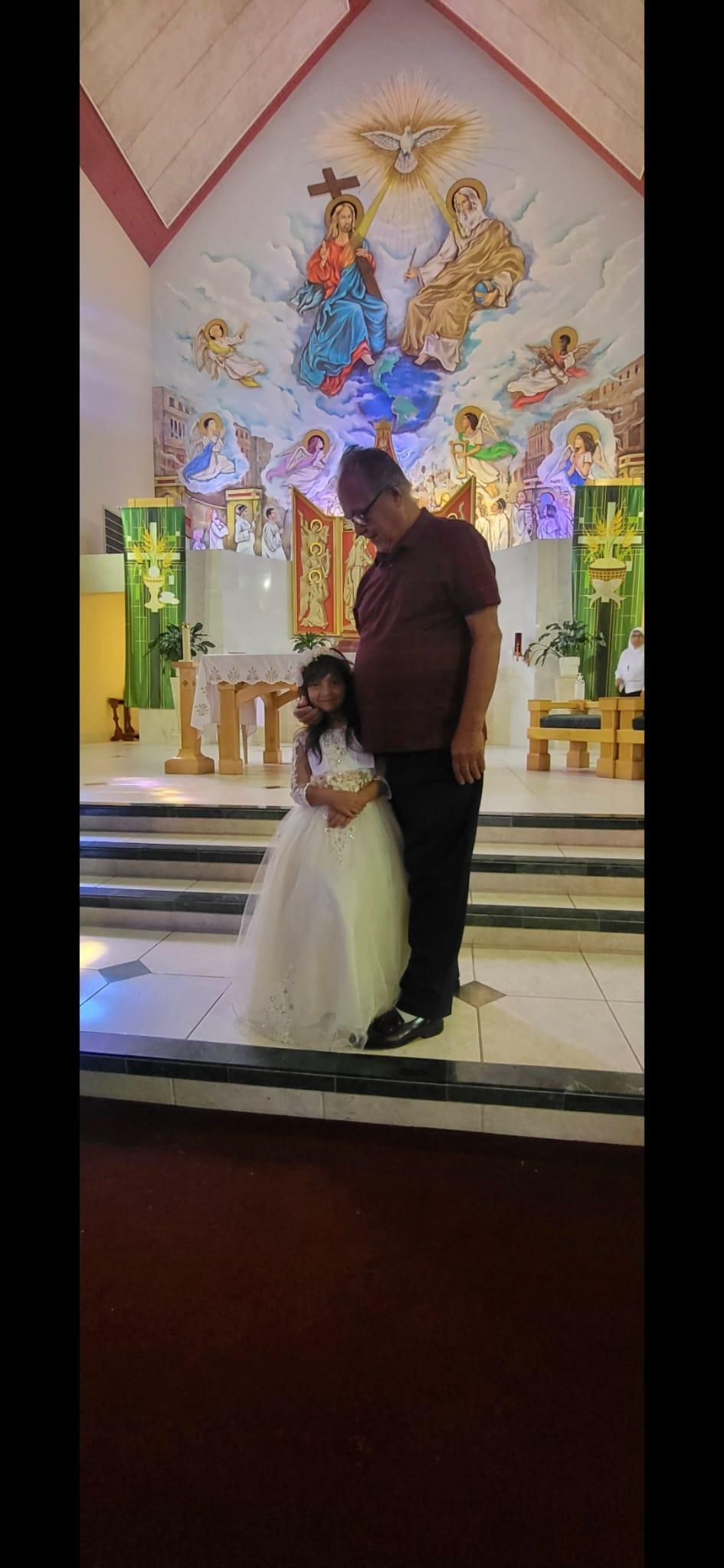 A man and girl posing for a picture
