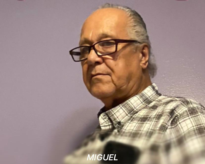 A man wearing glasses and a plaid shirt
