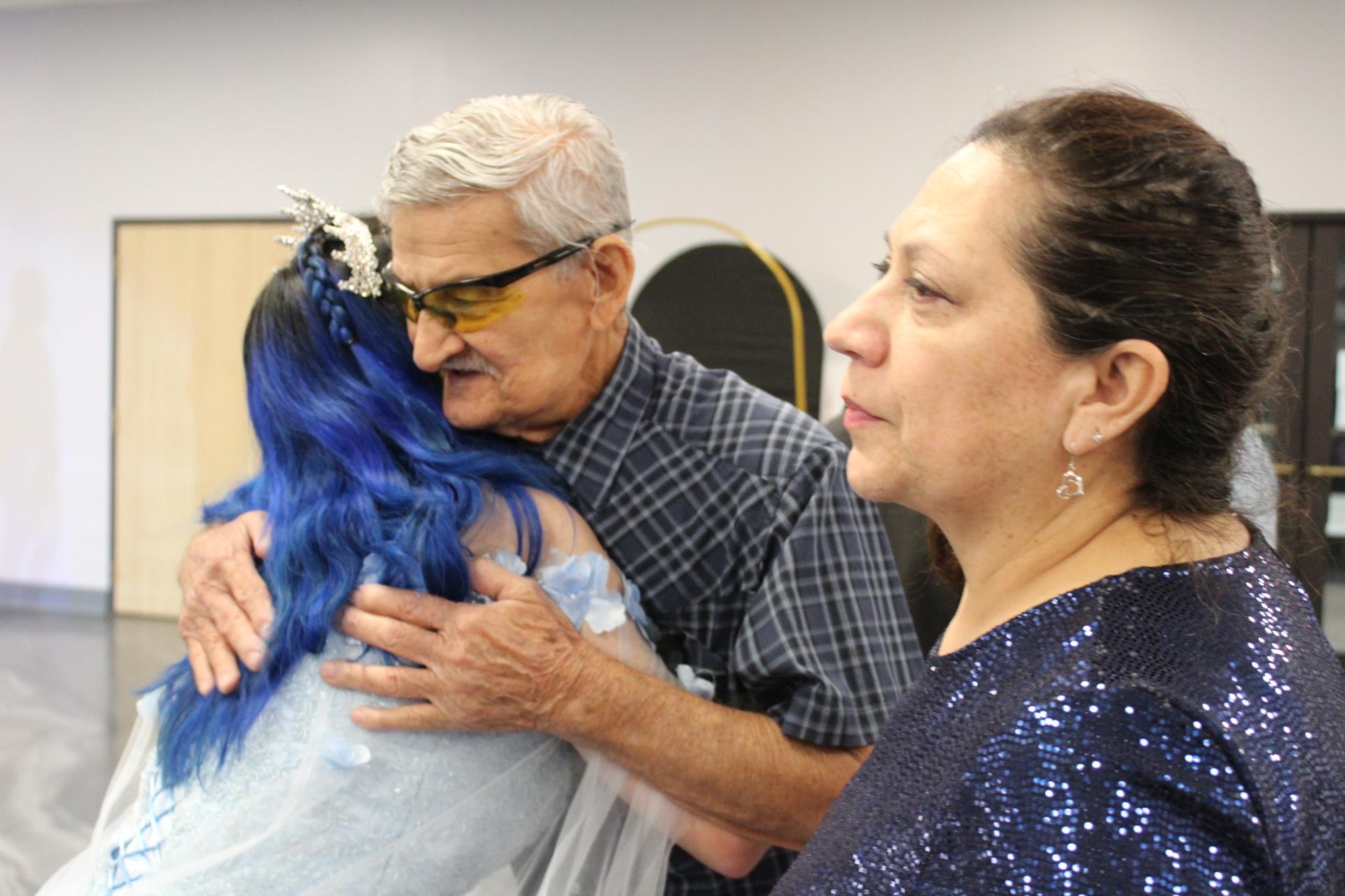 A man holding a woman's shoulder