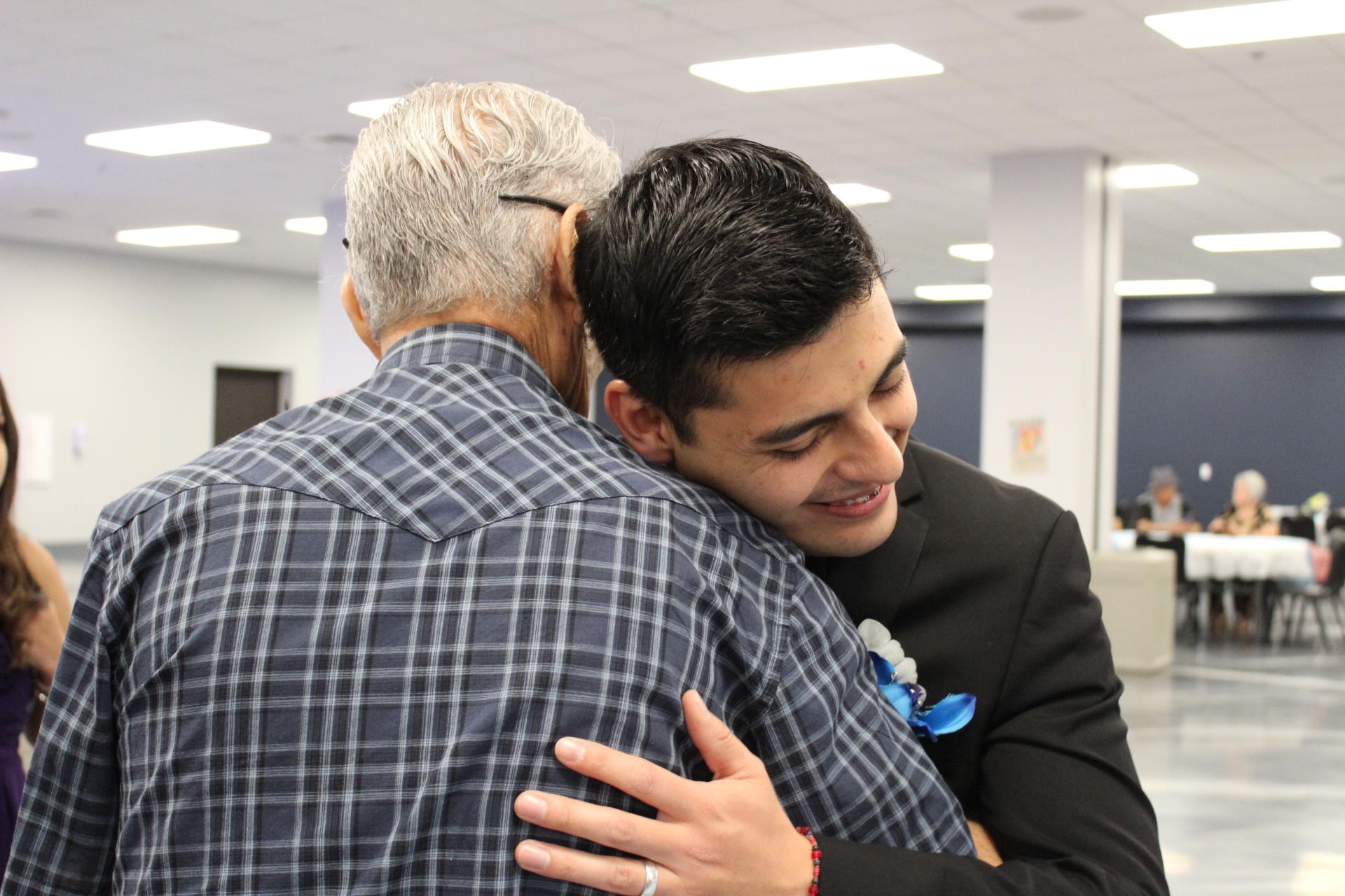 A man hugging another man