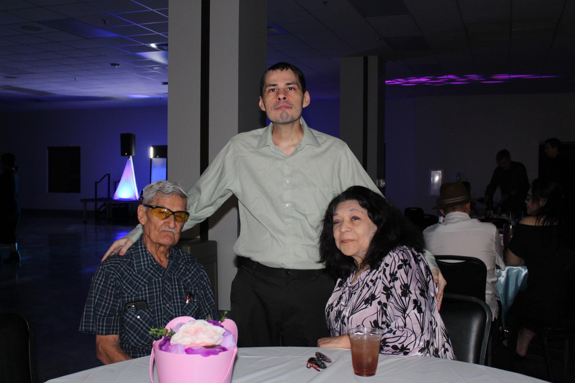 A man standing next to a woman and two men