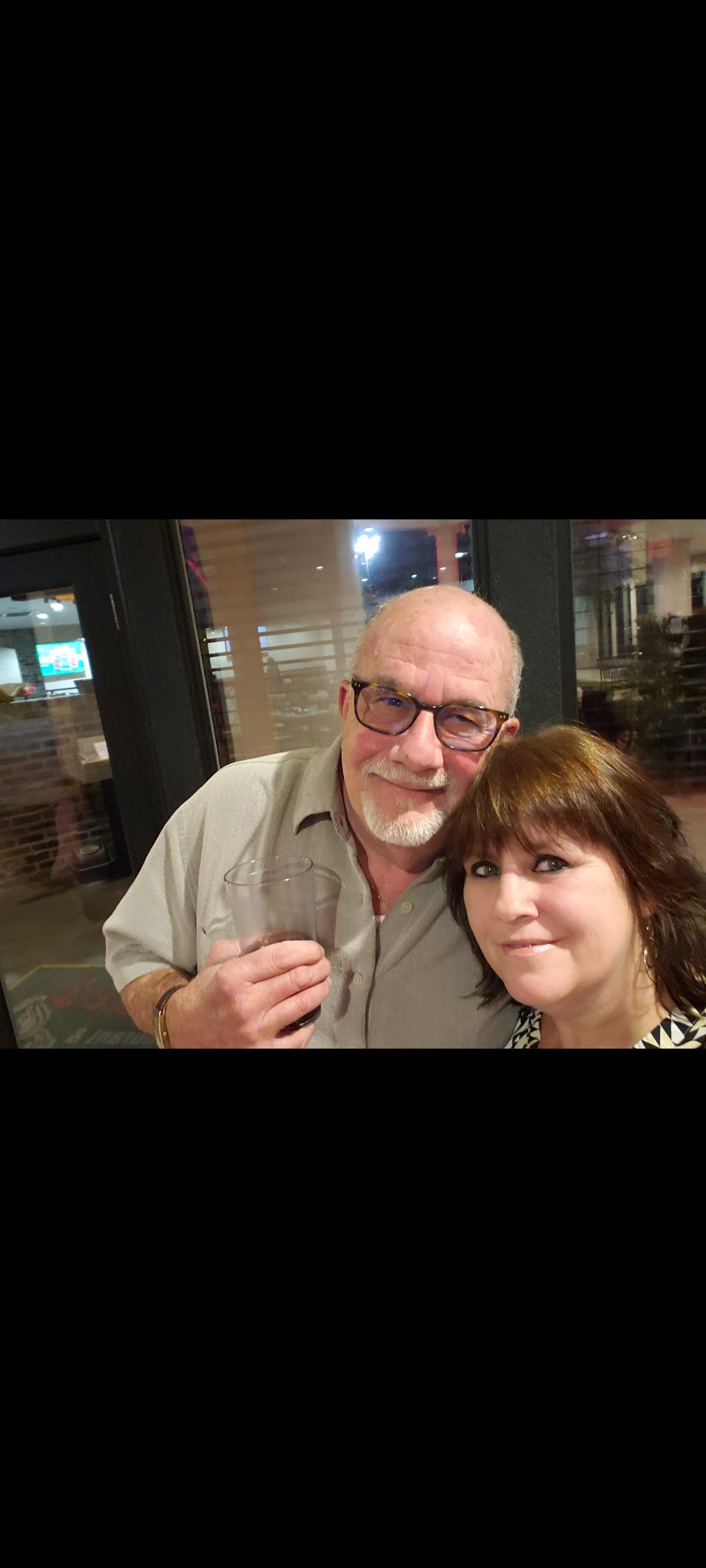 A man and woman posing for a picture