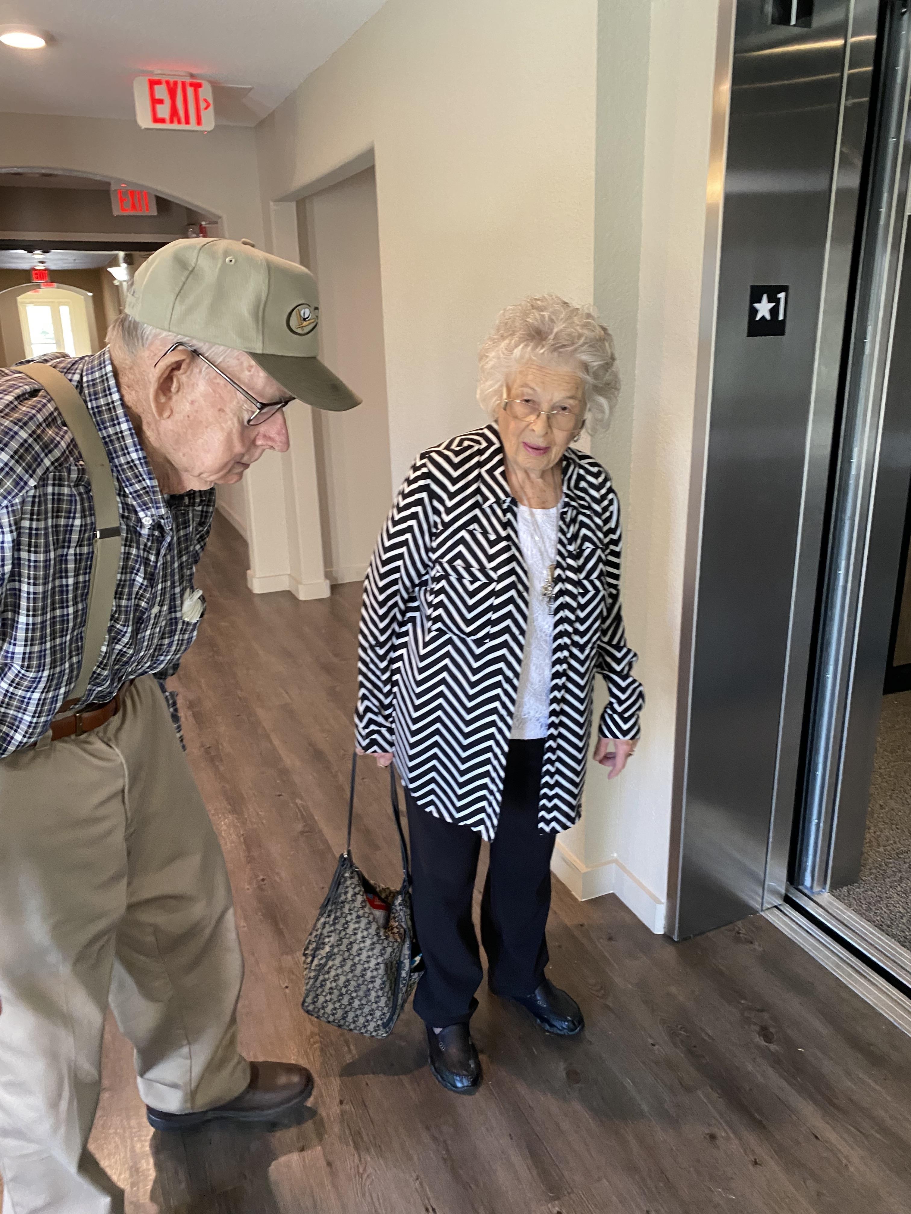 A man and woman standing in an elevator