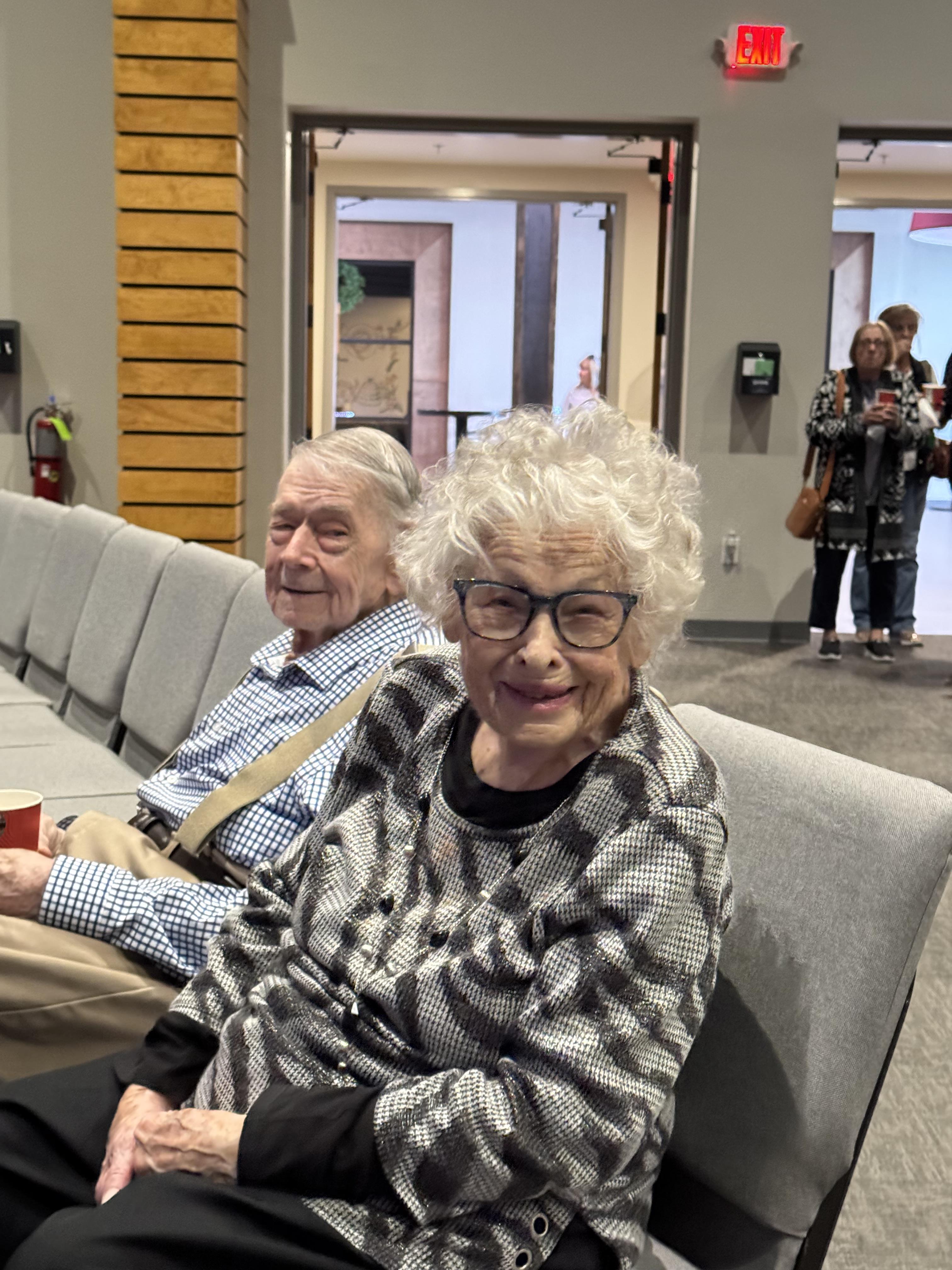 A man and woman sitting on a bench
