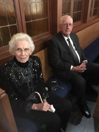 A man and woman sitting on a bench